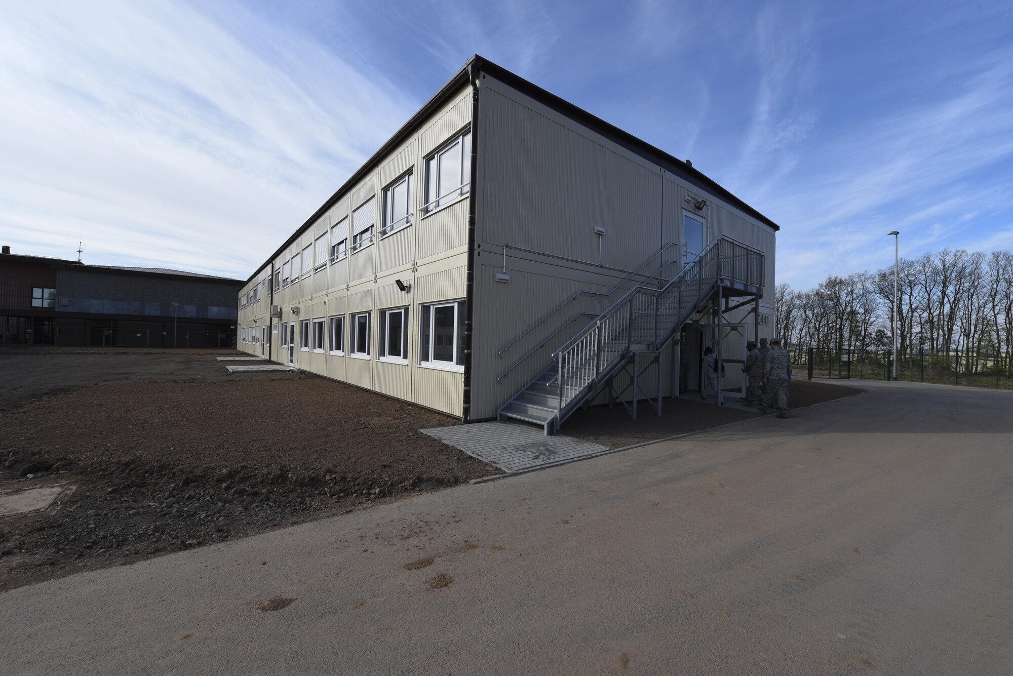 Wing leadership enters a new modular building during a tour at Spangdahlem Elementary School, Germany, April 26, 2017. The new two-story modular building includes up-to-date classrooms, bathrooms, a kitchen and all required utilities. (U.S. Air Force photo by Senior Airman Dawn M. Weber)