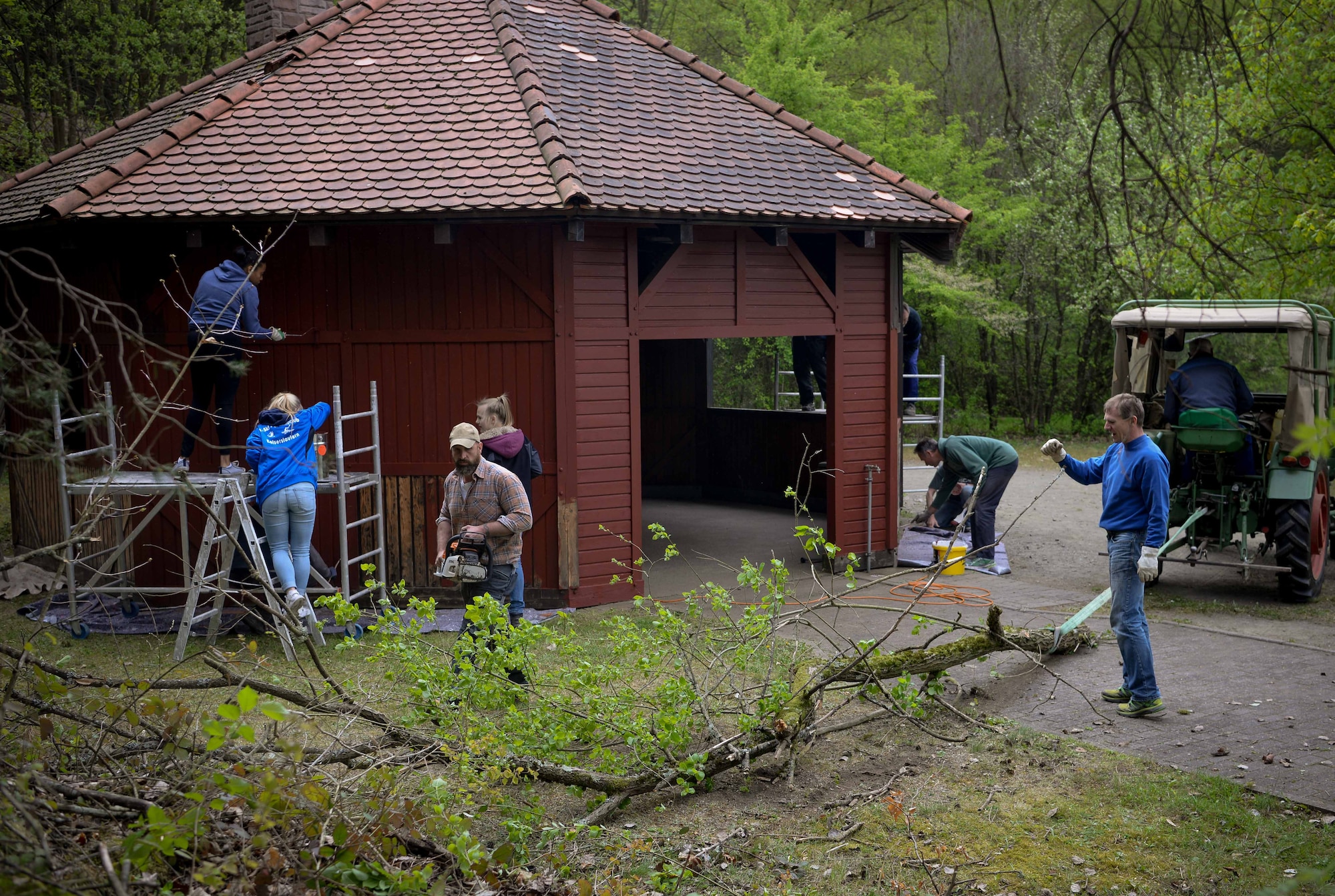 Volunteers from Ramstein Air Base and the town of Schwedelbach work together to repair a public barbecue pavilion in Schwedelbach, Germany, April 23, 2017. Airmen and local nationals teamed up through the 86th Airlift Wing Host Nations Office's Grassroots Program for Single Airmen to repair and beautify a public facility. The program aims to foster community and cross-cultural understanding between Airmen and the local community. (U.S. Air Force photo by Senior Airman Elizabeth Baker)