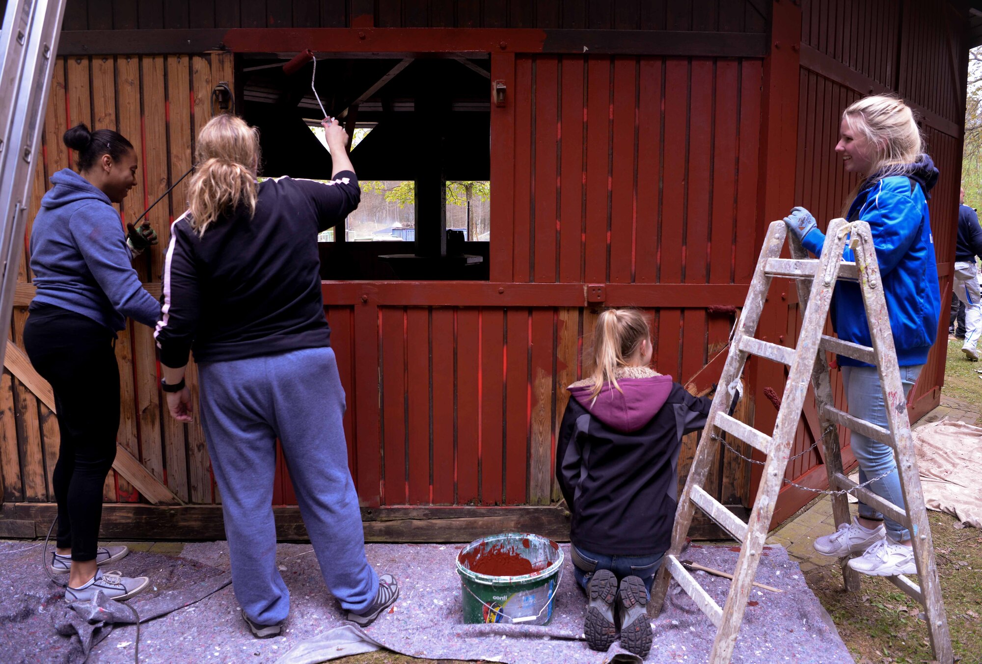 Volunteers from Ramstein Airbase and the town of Schwedelbach work together to repair a public barbecue pavilion in Schwedelbach, Germany, April 23, 2017. Airmen and local nationals teamed up through the 86th Airlift Wing Host Nations Office's Grassroots Program for Single Airmen to repair and beautify a public facility. The program aims to foster community and cross-cultural understanding between Airmen and the local community. (U.S. Air Force photo by Senior Airman Elizabeth Baker)