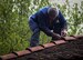 Heinz Rydzek, a local national volunteer from the town of Schwedelbach, repairs the roof of a barbecue pavilion in Schwedelbach, Germany, April 23, 2017. The 86th Airlift Wing Host Nations Office's Grassroots Program for Single Airmen brought together volunteers from Ramstein Air Base and local nationals from Schwedelbach to improve the community and foster cross-cultural understanding. The program intends to host more activities designed to bring the base and local national community together. (U.S. Air Force photo by Senior Airman Elizabeth Baker)