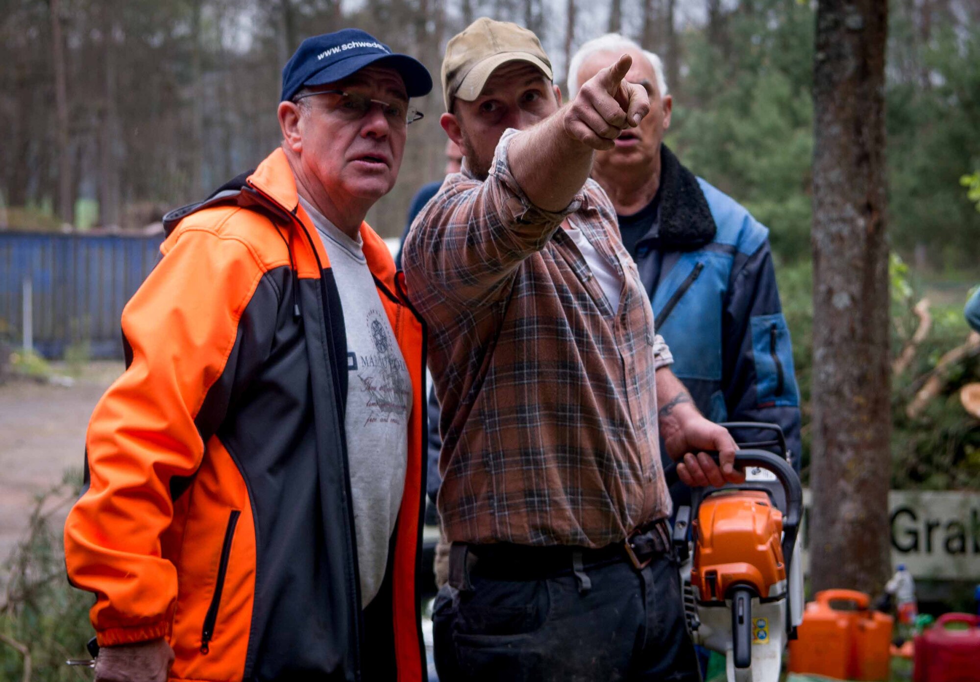 Dieter Hirsch, left, mayor of the town of Schwedelbach, and Uwe Klinck, a local national volunteer from Schwedelbach, decide which trees to clear from around a public barbecue pavilion in Schwedelbach, Germany, April 23, 2017. Airmen and local nationals teamed up to paint the pavilion, repair the roof and clears trees and brush away from the immediate area so that others may enjoy the facility. (U.S. Air Force photo by Senior Airman Elizabeth Baker)