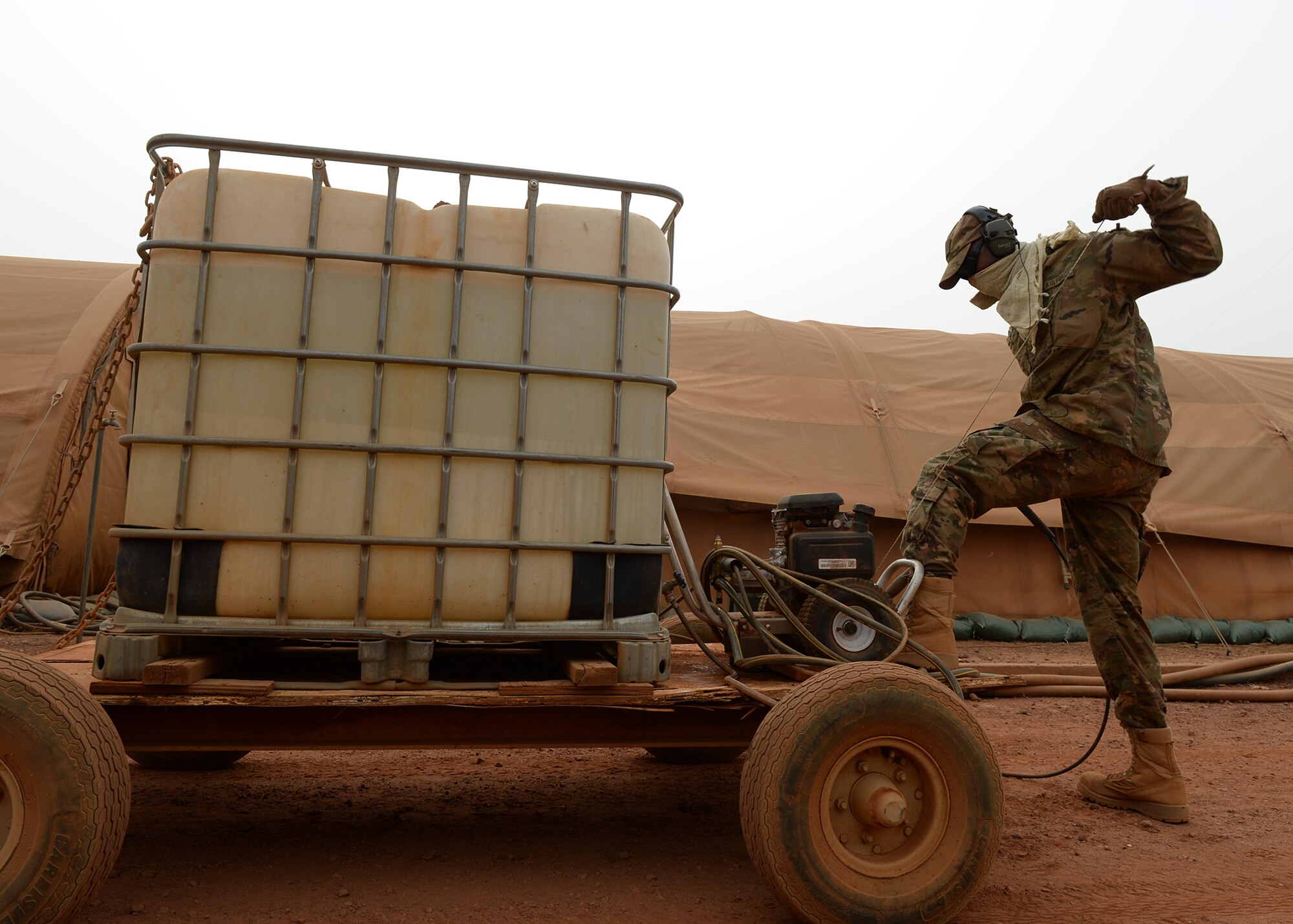 Staff Sgt. Julian Johnson, 768th Expeditionary Air Base Squadron NCO in charge of Heating Ventilation and Air Conditioning, pulls the starting cord for a pressure washer at Nigerien Air Base 101, Niger, April 3, 2017. As part of a two-man team, Johnson helps oversee approximately 120 HVAC units that supply air conditioning to U.S. facilities on the base. (U.S. Air Force photo by Senior Airman Jimmie D. Pike)