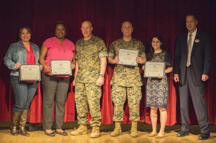 From left to right, Cortney Swieczkowski, a volunteer from the Girl Scouts of the United States of America and Marine Aviation Logistics Squadron (MALS) 12, Carla Bates, a volunteer from the Girl Scouts, U.S. Marine Corps Col. Richard F. Fuerst, commanding officer of Marine Corps Air Station Iwakuni, Gunnery Sgt. Joshua Oldham with MALS-12, April Rosales, a volunteer with the Navy-Marine Corps Relief Society and American Red Cross, and John Kasperski, Marine Corps Community Services Director, pose for a photo during the 8th Annual Installation Volunteer Ceremony at MCAS Iwakuni, Japan, April 26, 2017. The event was designed to show appreciation and recognition for service members and civilians who volunteered on the installation throughout 2016. Swieczkowski, Bates and Rosales were the top three civilians who contributed the most volunteer hours. Oldham was one of the top three active-duty service members who contributed the most volunteer hours. (U.S. Marine Corps photo by Pfc. Stephen Campbell)