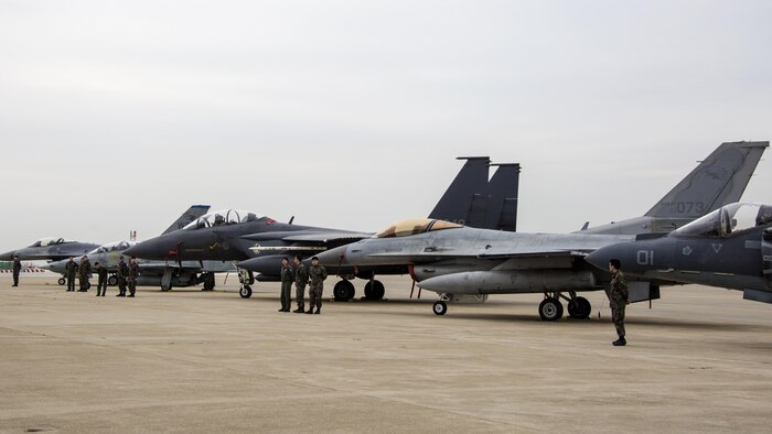 U.S. and Republic of Korea service members stand in front of static display aircraft during Exercise MAX THUNDER 17’s media day at Kunsan Air Base, ROK, April 20, 2017. Max Thunder serves as an opportunity for U.S. and ROK forces to train together and sharpen tactical skills for the defense of the Asia-Pacific region. It is an annual military-flying exercise built to promote interoperability between U.S. and ROK forces. (U.S. Marine Corps photo by Lance Cpl. Carlos Jimenez)