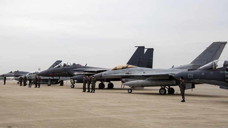 U.S. and Republic of Korea service members stand in front of static display aircraft during Exercise MAX THUNDER 17’s media day at Kunsan Air Base, ROK, April 20, 2017. Max Thunder serves as an opportunity for U.S. and ROK forces to train together and sharpen tactical skills for the defense of the Asia-Pacific region. It is an annual military-flying exercise built to promote interoperability between U.S. and ROK forces. (U.S. Marine Corps photo by Lance Cpl. Carlos Jimenez)