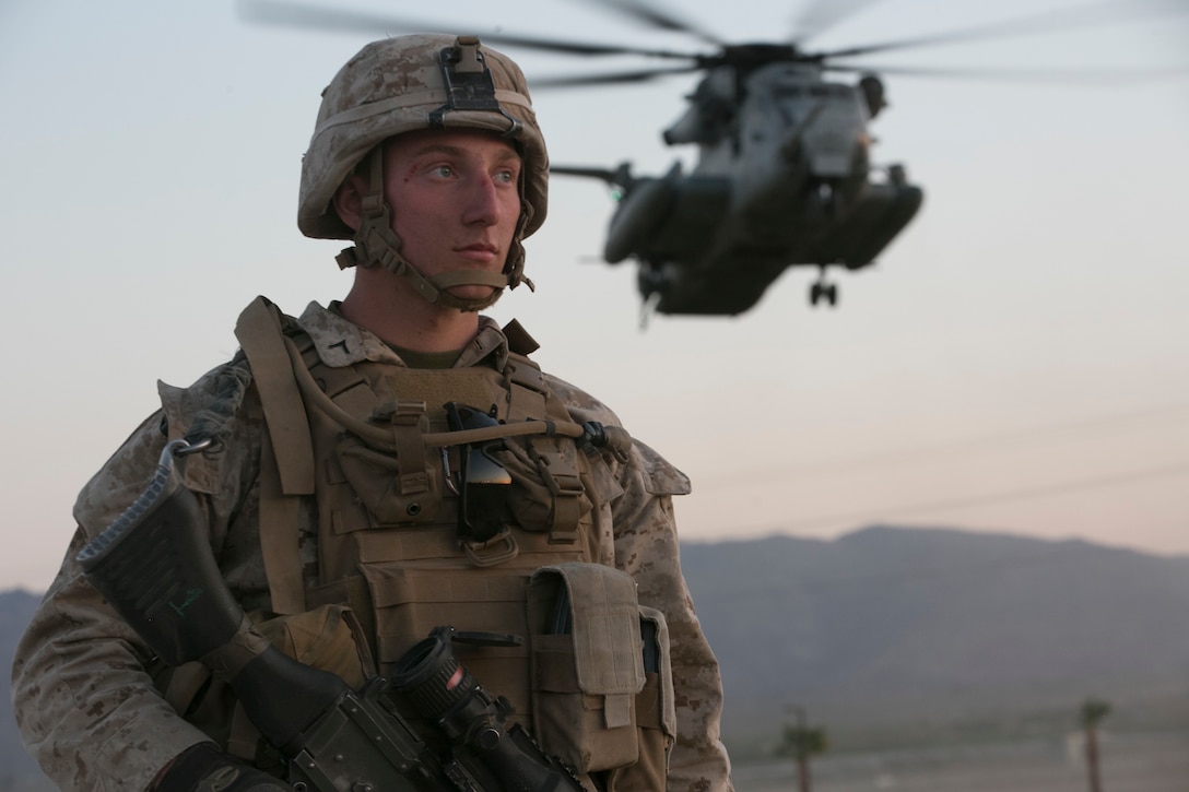 Pfc. Benjamin Kelly, machinegunner, 2nd Battalion, 6th Marine Regiment, provides security as a CH-53 ‘Super Stallion’ helicopter lands at Del Valle Field during a non-combatant Evacuation Operation exercise as part of Weapons and Tactics Instructor Course 2-17  at Marine Corps Air Ground Combat Center Twentynine Palms, Calif., April 21, 2017. NEO exercises simulate real-life scenarios where non-combatants are evacuated from a potentially hostile area.