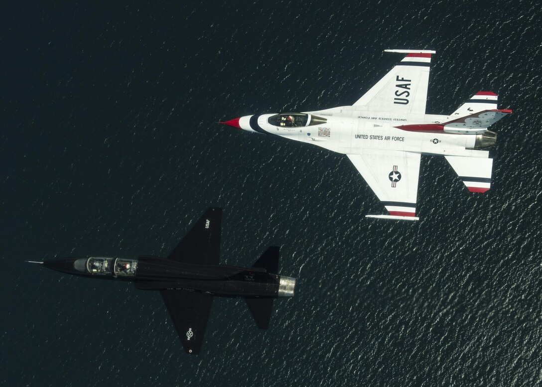 Maj. Nick Krajicek, a T-38 Talon pilot, flies in a two-ship formation with retired Lt. Col. Dale Cooke, a former T-38 pilot, over Tyndall Air Force Base and Panama City, Fla., April 21, 2017. The T-38 in the formation was the same jet Cooke flew during his tenure on the team. The Thunderbirds transitioned from the T-38 to the F-16 in 1982. (U.S. Air Force photo/Tech. Sgt. Christopher Boitz)