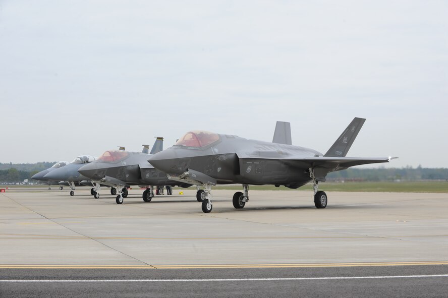 Two F-35As and two F-15Cs wait at the end of the runway at RAF Lakenheath prior to a training sortie. Airmen from the 388th and 419th Fighter Wings at Hill Air Force Base, Utah, deployed the F-35A overseas for the first time. While in Europe, they will train with units from the U.S. Air Force, Royal Air Force and air forces from other NATO allies. (U.S. Air Force photo/Micah Garbarino)