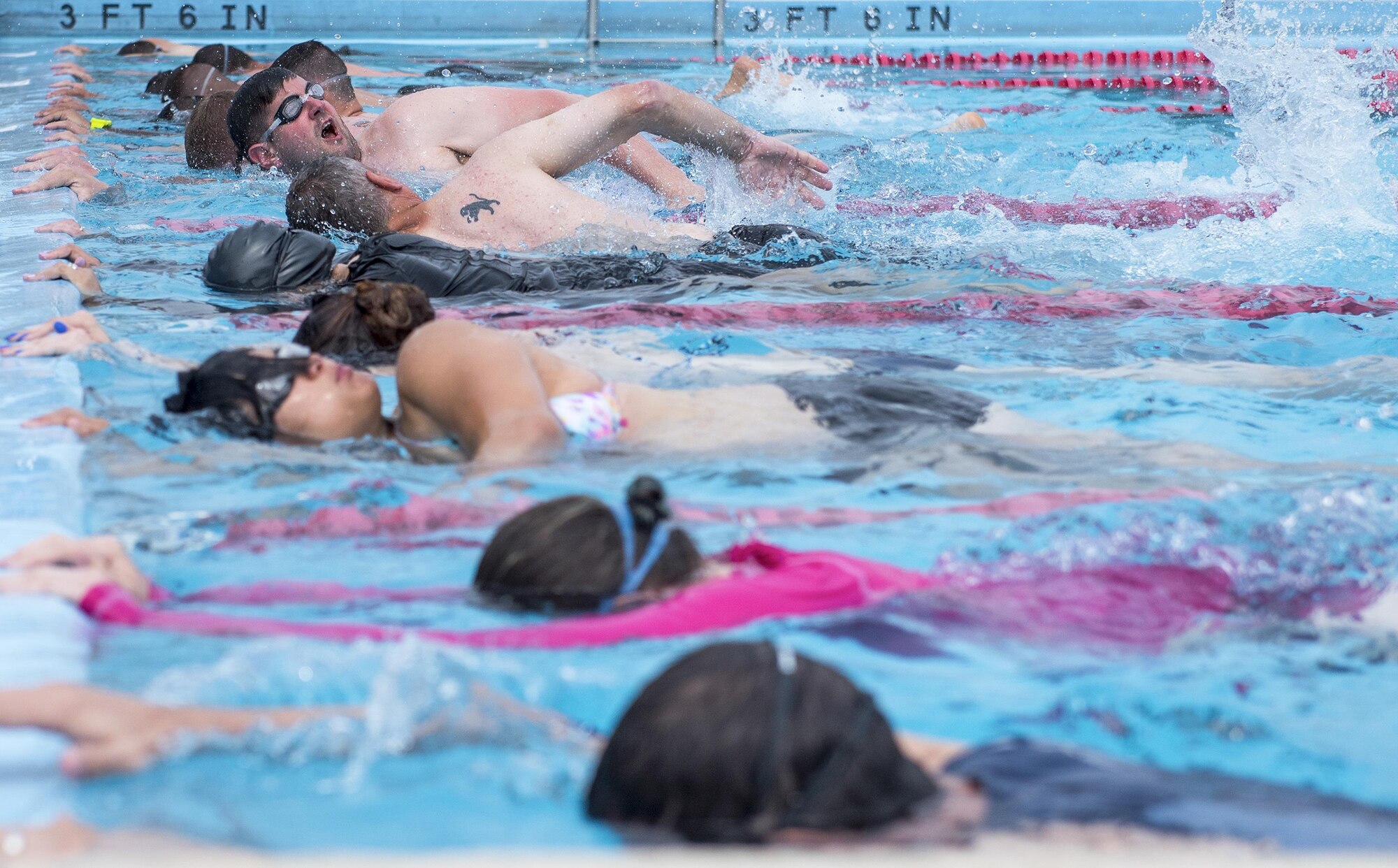 A row of Warrior CARE athletes learns proper techniques in the swimming session of the adaptive sports camp at Eglin Air Force Base, Fla., April 27. The base hosts the week-long Wound Warrior CARE event that helps recovering wounded, ill and injured military members through specific hand-on rehabilitative training. (U.S. Air Force photo/Samuel King Jr.)