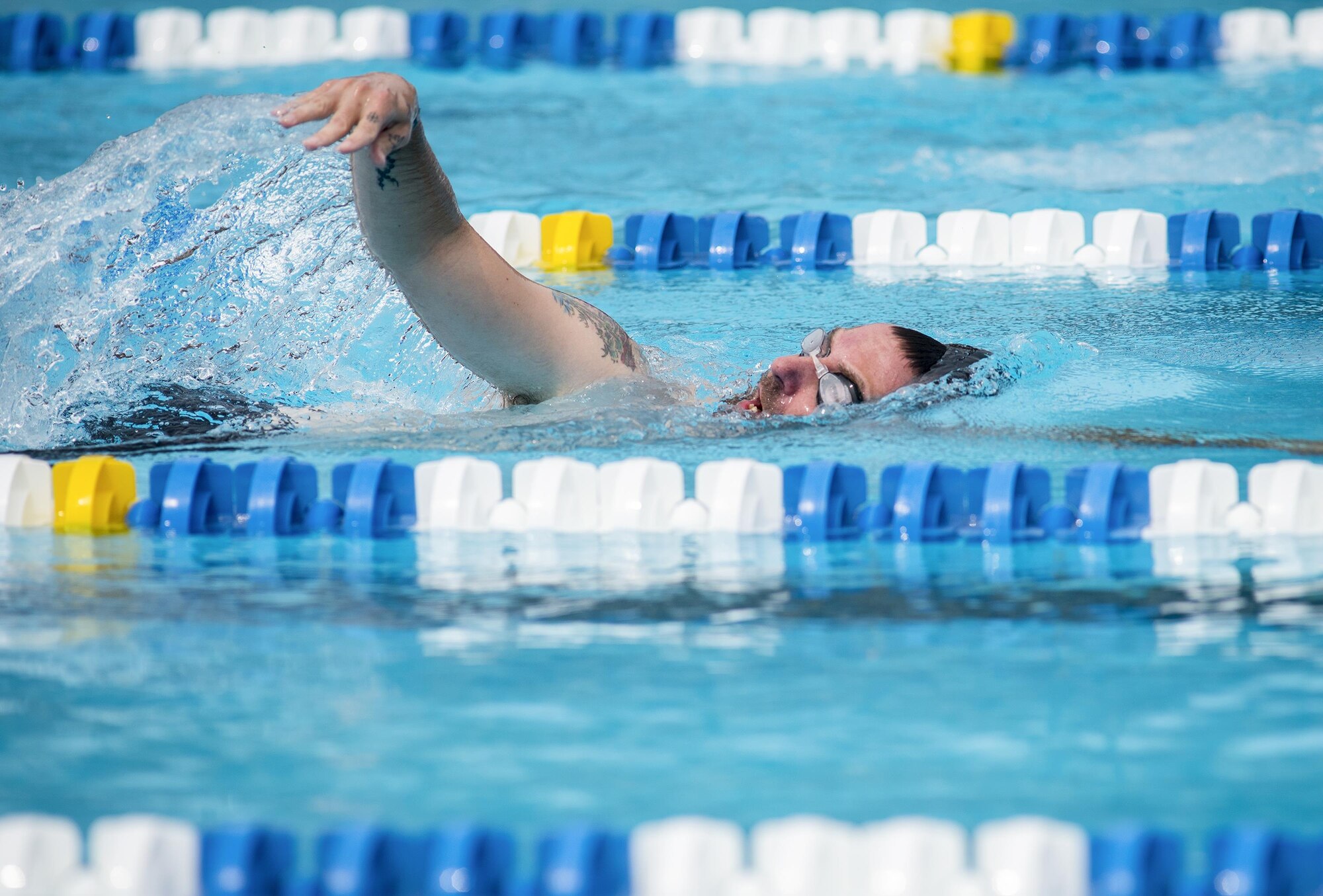 Casey Dockins, a Warrior CARE athlete, takes in breath while completing a lap in the swimming session of the adaptive sports camp at Eglin Air Force Base, Fla., April 27. The base hosts the week-long Wound Warrior CARE event that helps recovering wounded, ill and injured military members through specific hand-on rehabilitative training. (U.S. Air Force photo/Samuel King Jr.)