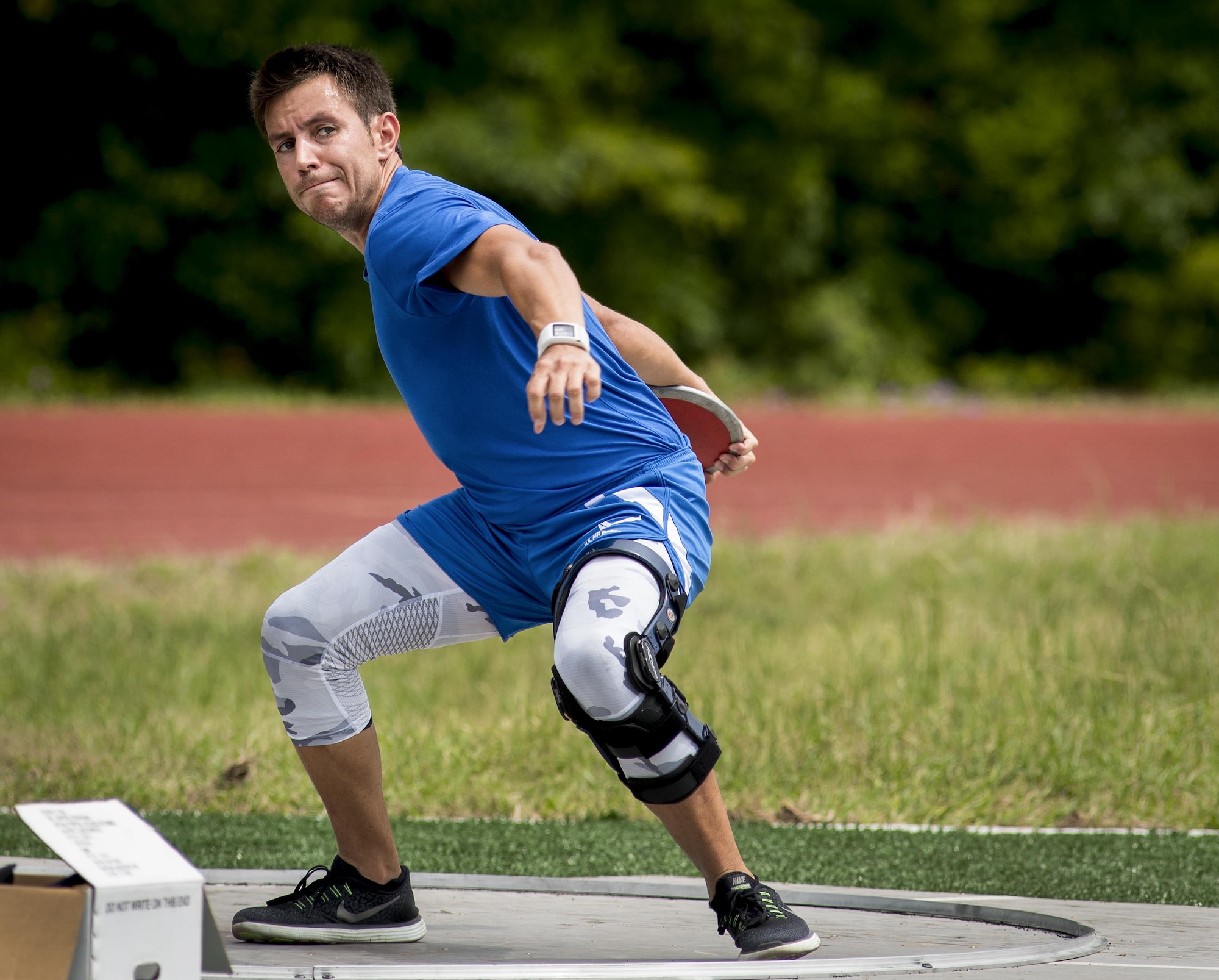 Master Sgt. Keith Guinn, a Warrior Games athlete, begins his discus rotation during a track and field session at the Air Force team’s training camp at Eglin Air Force Base, Fla., April 27. The base-hosted, week-long Warrior Games training camp is the last team practice session before the yearly competition in June. (U.S. Air Force photo/Samuel King Jr.)