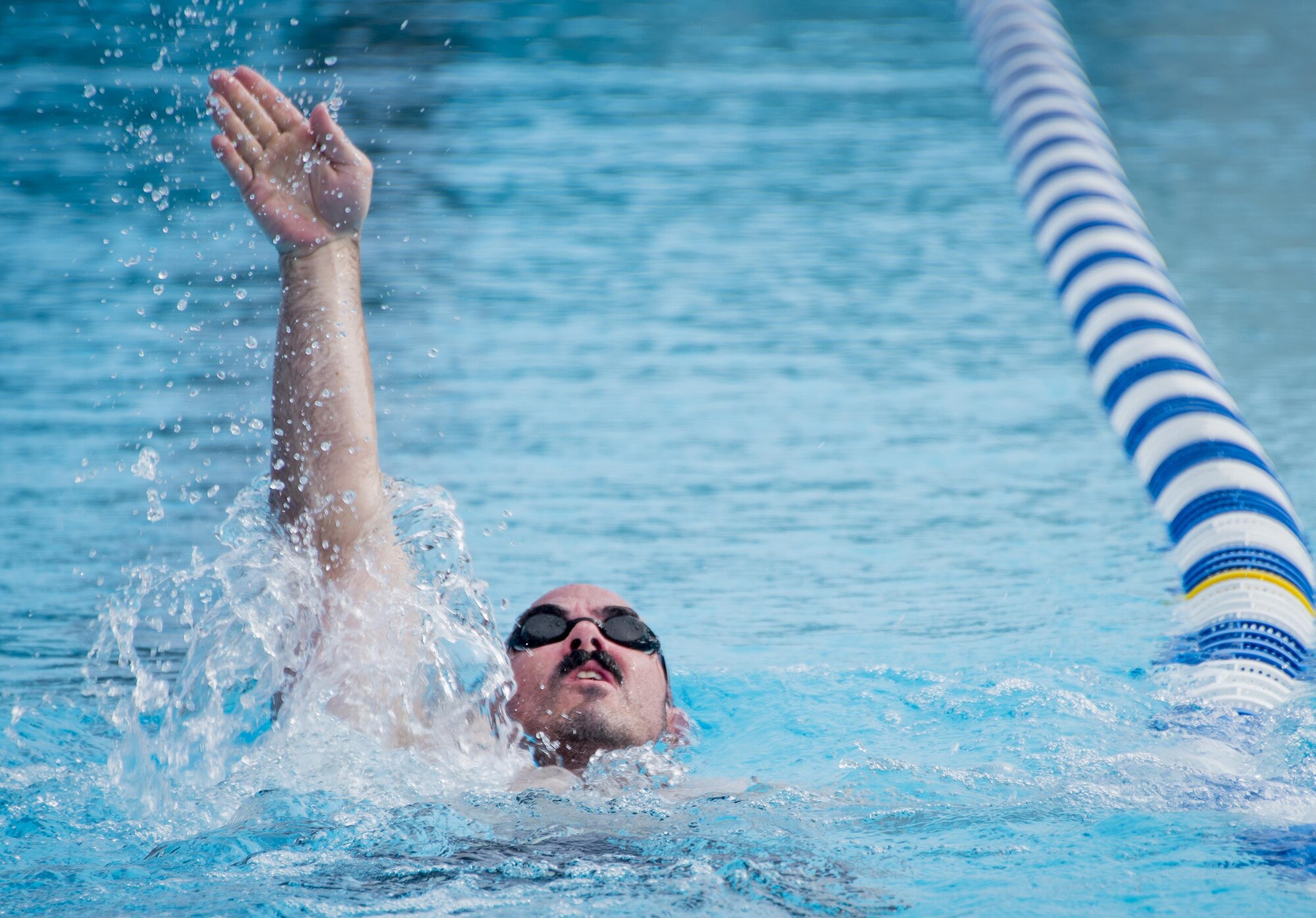 Tech. Sgt. Jason Caswell, a Warrior Games athlete, practices the backstroke during a swimming session at the Air Force team’s training camp at Eglin Air Force Base, Fla., April 27. The base-hosted, week-long Warrior Games training camp is the last team practice session before the yearly competition in June. (U.S. Air Force photo/Ilka Cole)