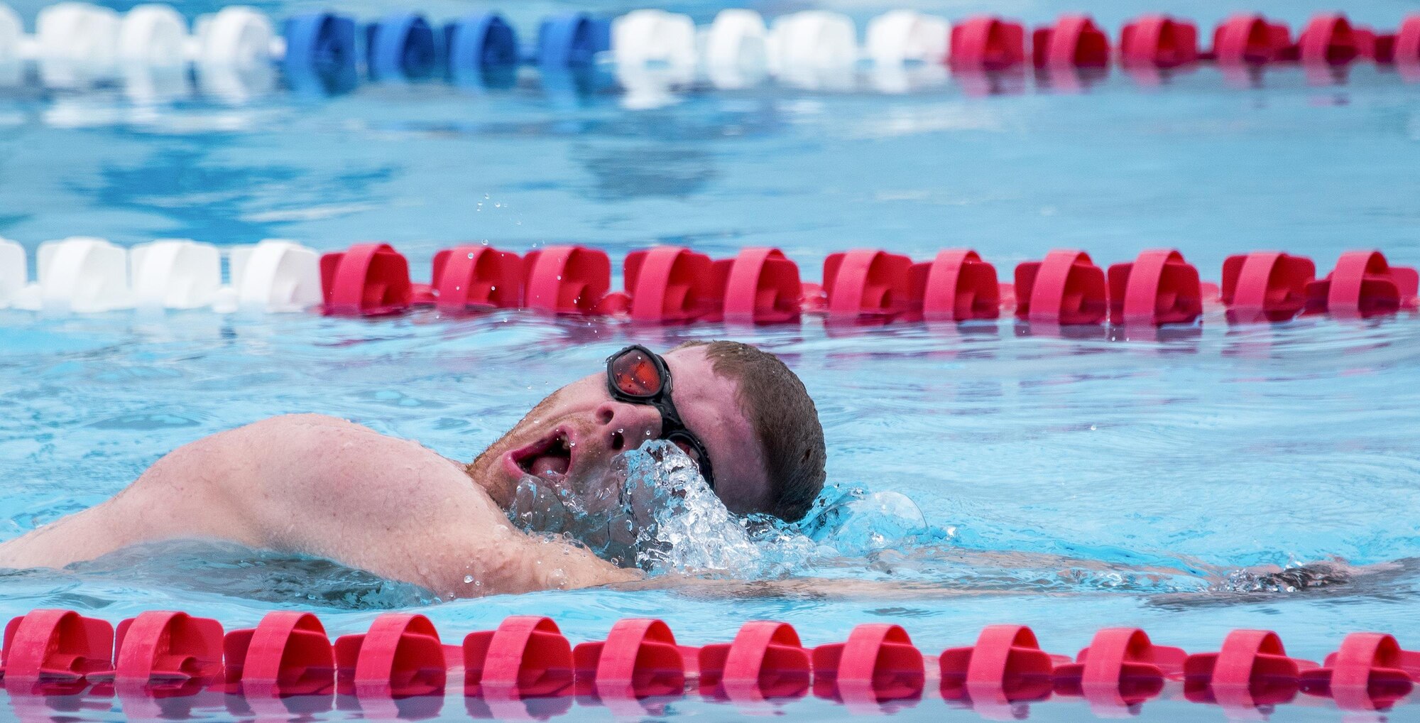 Luke Kitson, a Warrior CARE athlete, takes in breath while completing a lap in the swimming session of the adaptive sports camp at Eglin Air Force Base, Fla., April 27. The base hosts the week-long Wound Warrior CARE event that helps recovering wounded, ill and injured military members through specific hand-on rehabilitative training. (U.S. Air Force photo/Samuel King Jr.)
