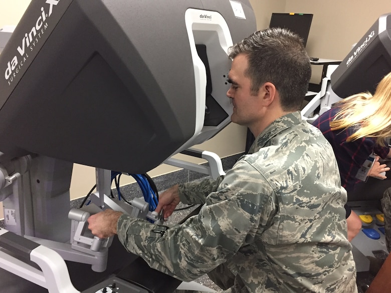 Maj. (Dr.) Toby Lees, urologist, Surgical Specialties Flight commander, 88th Medical Group, manipulates the da Vinci Xi surgical robotic system from one of its two consoles during the new system’s unveiling at the Wright-Patterson Medical CenterApril 20.(Skywrighter photo/Amy Rollins)