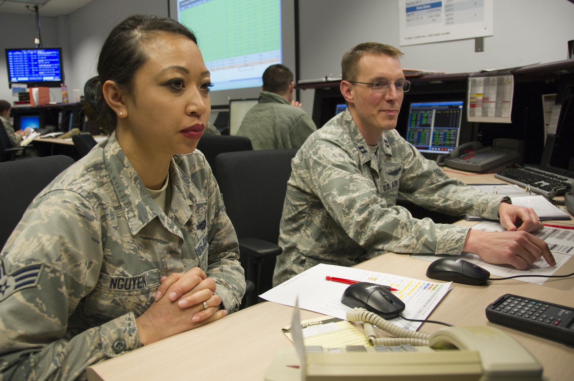 SCHRIEVER AIR FORCE BASE, Colo. -- Senior Airman Hannah Nguyen and Capt. Cuyler Gembol, 6th Space Operations Squadron, monitor satellite activity during a Continuity of Operations training event with the National Oceanic and Atmospheric Administration on Monday, Apr. 24th, 2017. 6 SOPS provides backup to NOAA, the main operators of the Defense Meteorological Satellite Program (DMSP) satellites, in the event that NOAA's systems become inoperable. (U.S. Air Force photo/Senior Airman Laura Turner)