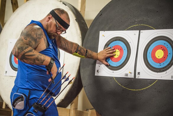 A Warrior CARE athlete, Ed Loves pulls his arrows from the target during an archery session at the adaptive sports camp at Eglin Air Force Base, Fla., April 26. The base hosts the week-long Wounded Warrior CARE event that helps recovering wounded, ill and injured military members through specific hand-on rehabilitative training. (U.S. Air Force photo/Ilka Cole)