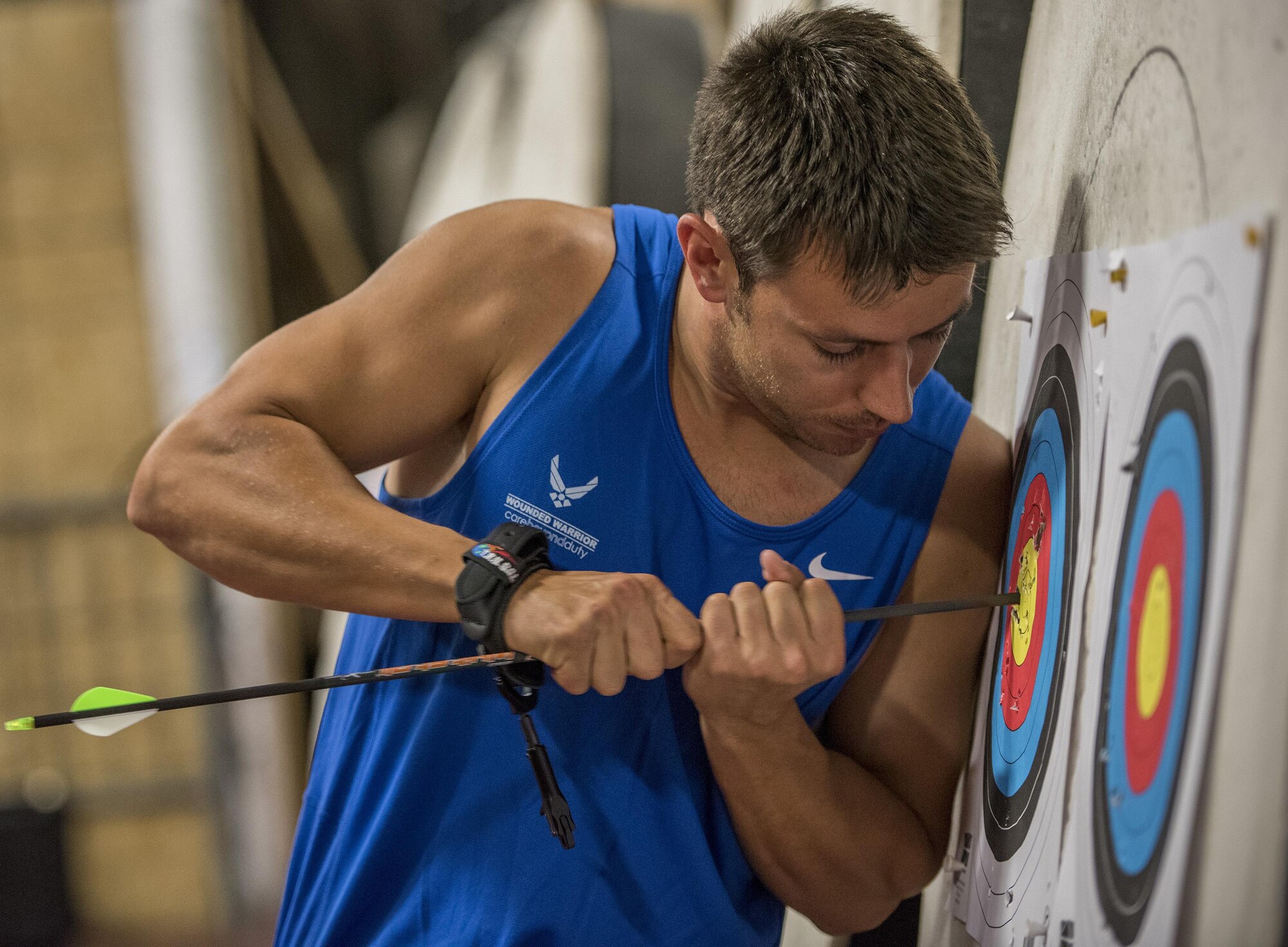 A Warrior CARE athlete, Kenneth Guinn pulls his arrows from the target during an archery session at the adaptive sports camp at Eglin Air Force Base, Fla., April 26. The base hosts the week-long Wounded Warrior CARE event that helps recovering wounded, ill and injured military members through specific hand-on rehabilitative training. (U.S. Air Force photo/Ilka Cole)