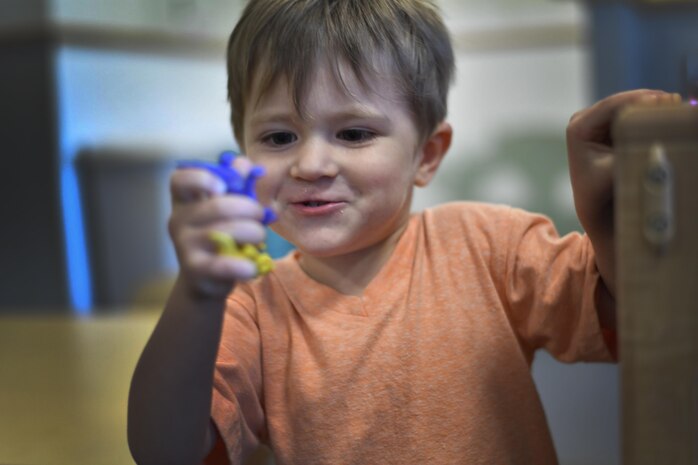 Royce, a military child, plays with plastic dinosaurs at the Joint Base Charleston Child Development Center in South Carolina, April 6, 2017. April was named Month of the Military Child by former Defense Secretary Casper Weinberger in 1989 to applaud military children for their daily sacrifices.