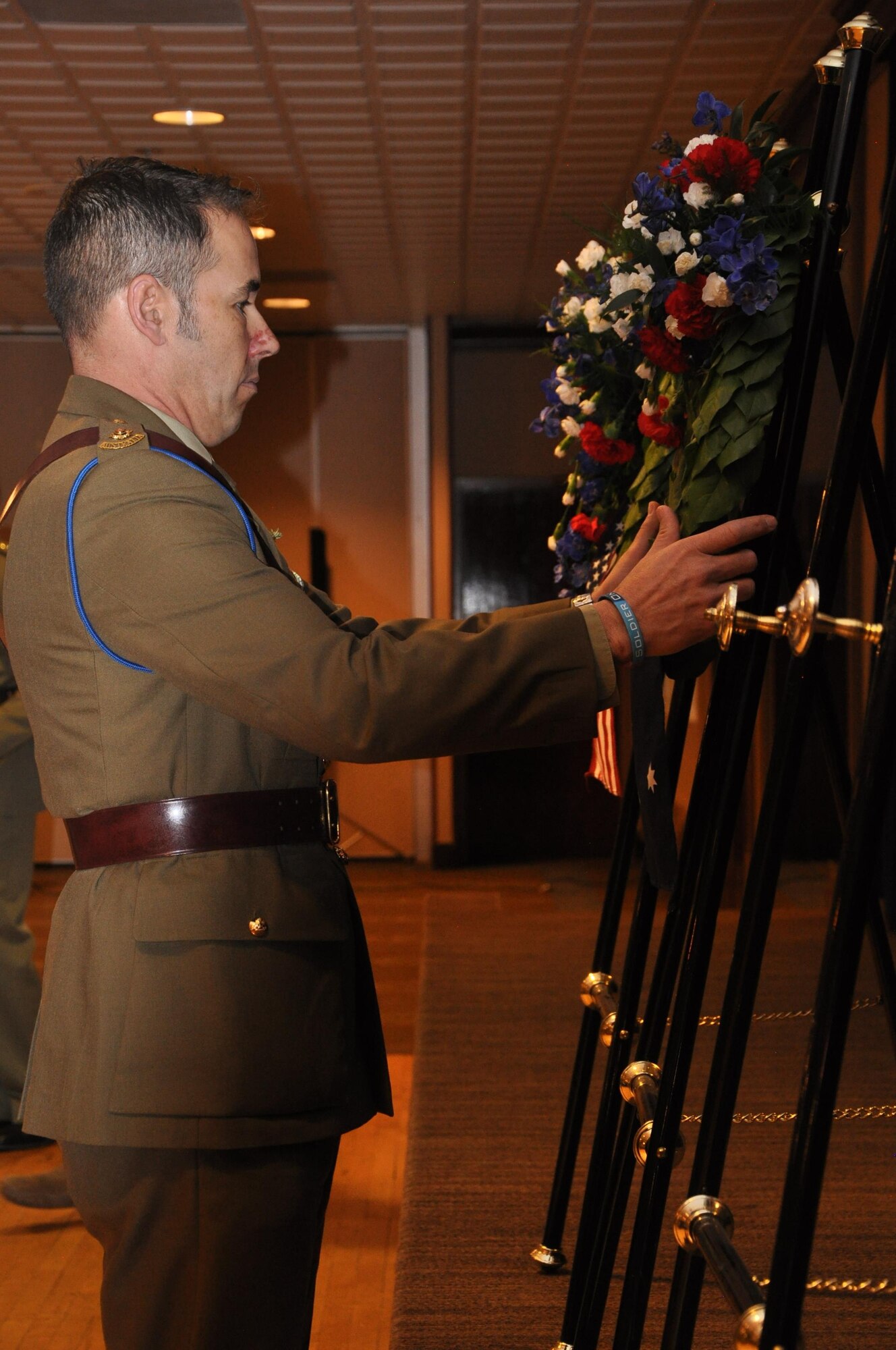 PETERSON AIR FORCE BASE, Colo. – Australian Army Lt. Col. Simon McDonald, U.S. Army Space and Missile Defense Command/Army Forces Strategic Command satellite communications operations officer, places a wreath on behalf of Australia during an Australian and New Zealand Army Corps Day Dawn Service at The Club, April 25, at Peterson Air Force Base, Colo. Marking the 101st ANZAC Day, approximately 75 U.S. and Australian service members commemorated not only the ANZAC entrance into World War I as an independent nation but also to remember all those who have given the ultimate sacrifice in all conflicts. (U.S. Army photo by Scott Andreae)