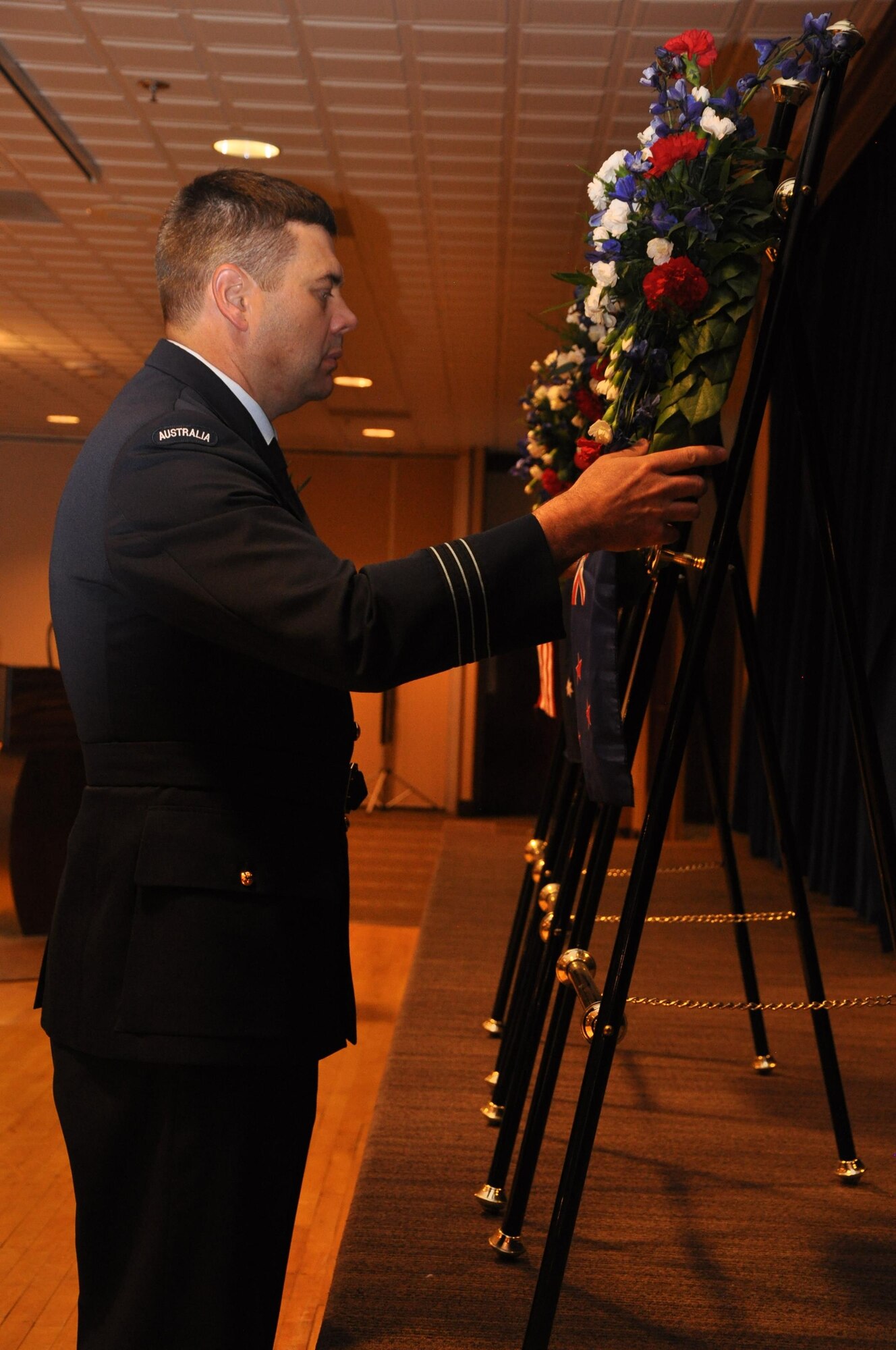 PETERSON AIR FORCE BASE, Colo. – Royal Australian Air Force Wing Commander Stuart Briese, U.S. Air Force Space Command, places a wreath on behalf of New Zealand during an Australian and New Zealand Army Corps Day Dawn Service at The Club, April 25, at Peterson Air Force Base, Colo. Marking the 101st ANZAC Day, approximately 75 U.S. and Australian service members commemorated not only the ANZAC entrance into World War I as an independent nation but also to remember all those who have given the ultimate sacrifice in all conflicts. (U.S. Army photo by Scott Andreae)