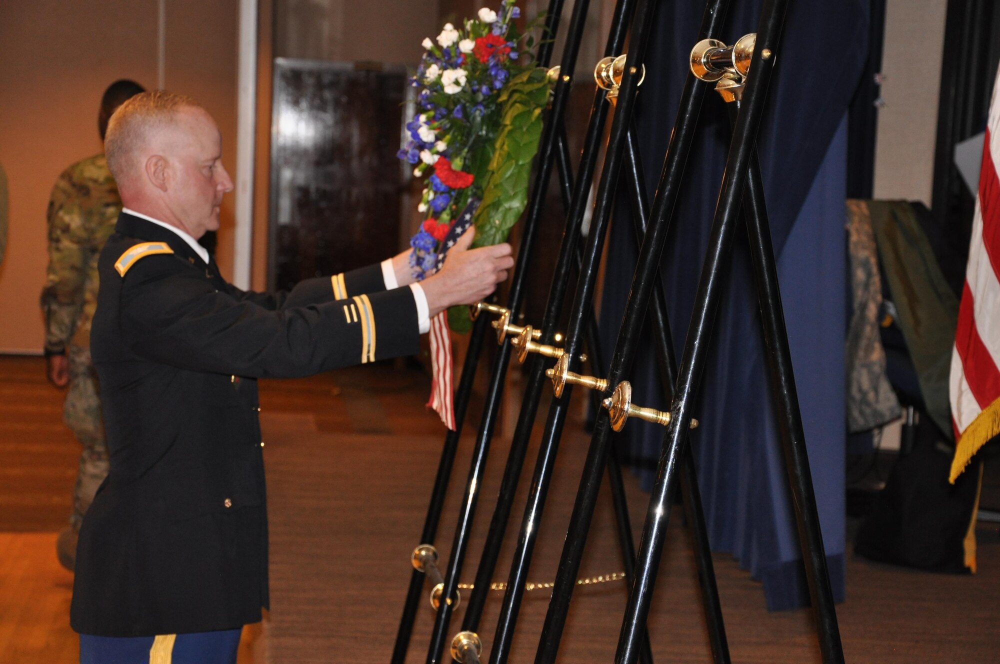 PETERSON AIR FORCE BASE, Colo. – U.S. Army Col. Tim Lawson, U.S. Army Space and Missile Defense Command/Army Forces Strategic Command support deputy commander, places a wreath on behalf of the U.S. during an Australian and New Zealand Army Corps Day Dawn Service at The Club, April 25, at Peterson Air Force Base, Colo. Marking the 101st ANZAC Day, approximately 75 U.S. and Australian service members commemorated not only the ANZAC entrance into World War I as an independent nation but also to remember all those who have given the ultimate sacrifice in all conflicts. (U.S. Army photo by Scott Andreae)