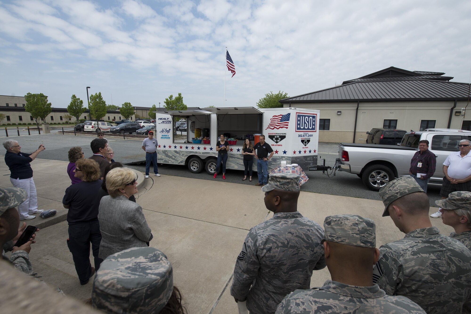 Military members and USO Delaware volunteers gather for the dedication of a new food trailer April 27, 2017, at the USO headquarters on Dover Air Force Base, Del. The food truck will be used at military appreciation and recruiting events throughout the state. (U.S. Air Force photo by Senior Airman Aaron J. Jenne)