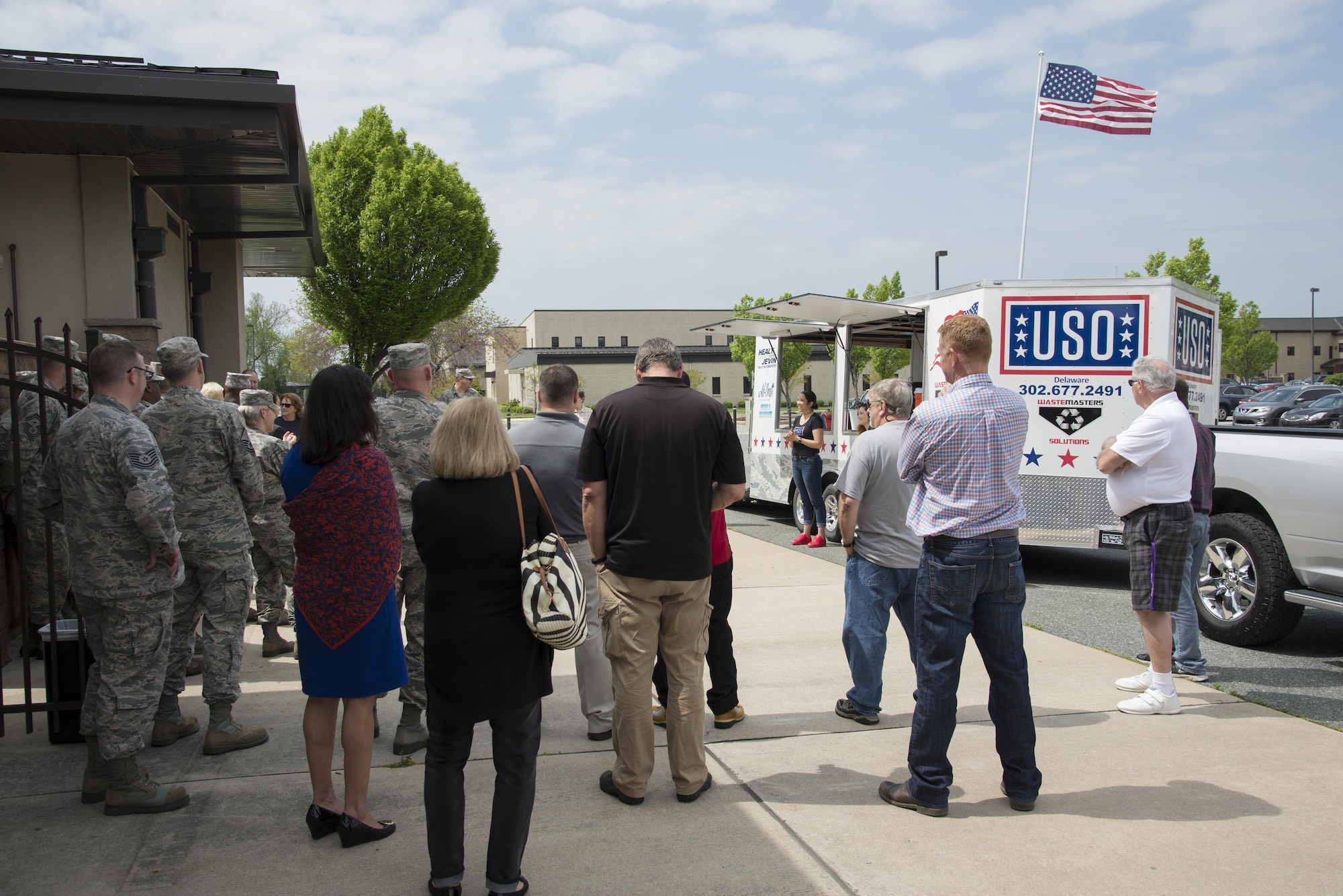 USO Delaware volunteers and military members gather for the dedication of a new food trailer April 27, 2017, at the USO headquarters on Dover Air Force Base, Del. More than 30 Team Dover members attended the dedication ceremony. (U.S. Air Force photo by Senior Airman Aaron J. Jenne)