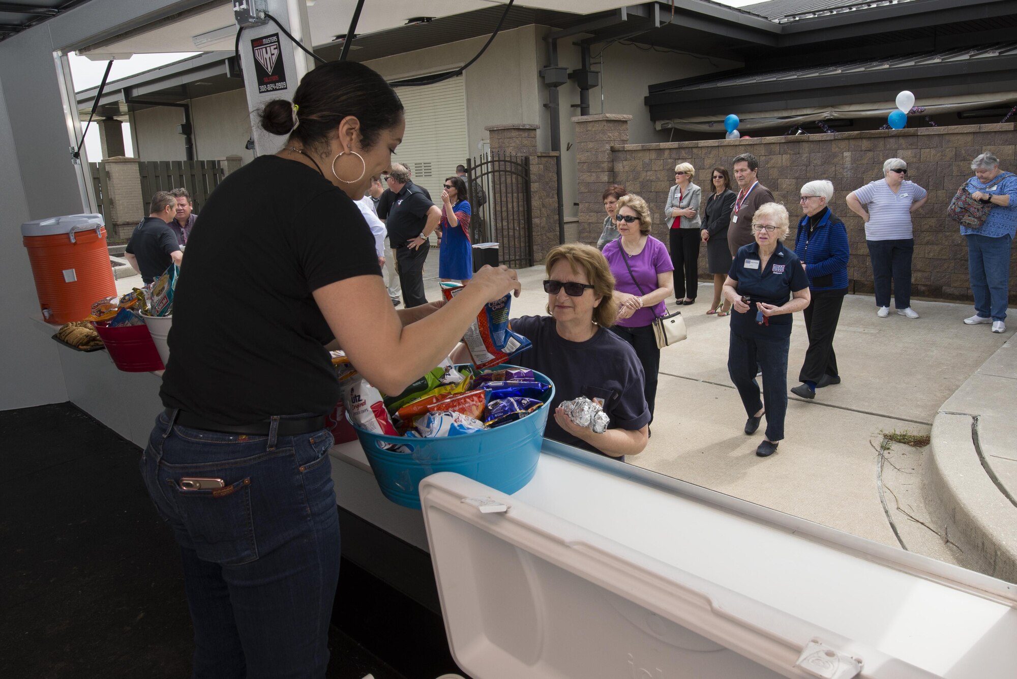 Yolanda Bottorf, USO Delaware operations programs manager, hands out free food from a new food trailer April 27, 2017, at the USO headquarters on Dover Air Force Base, Del. The food trailer was donated to support the USO’s mission to keep service members and veterans connected to family, home and country. (U.S. Air Force photo by Senior Airman Aaron J. Jenne)