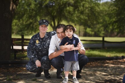U.S. Navy Petty Officer 2nd Class Amandda Yeager, left, embraces her husband, Kevin Yeager, right, and their son at Menriv Park on Joint Base Charleston - Weapons Station, S.C., April 27, 2017. Kevin Yeager is military spouse and a former Sailor in the U.S. Navy. In 1999, Congress designated the Friday before Mother’s Day as Military Spouse Appreciation Day to show appreciation for the sacrifices of military spouses.