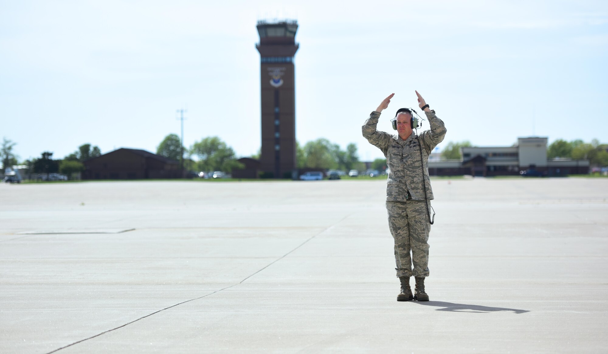 U.S. Air Force Chief Master Sgt. Darron Hunter, the 509th Maintenance Group (MXG) superintendent, performs pre-flight checks on a B-2 Spirit and signals to the mission commander that he is clear and free to move to the runway at Whiteman Air Force Base, Mo., April 24, 2017. During Hunter’s first assignment at Whiteman, he served as the dedicated crew chief (DCC) on the Spirit of Kitty Hawk, tail number 93-1086, from 2000 to 2002, before moving into Quality Assurance and Production for another seven years. In 2015, Hunter returned to the 509th as the MXG superintendent, bringing his career full circle before retiring. For one last farewell, Hunter once more performed the role of the DCC for his old aircraft, "1086." (U.S. Air Force photo by Airman 1st Class Jazmin Smith)