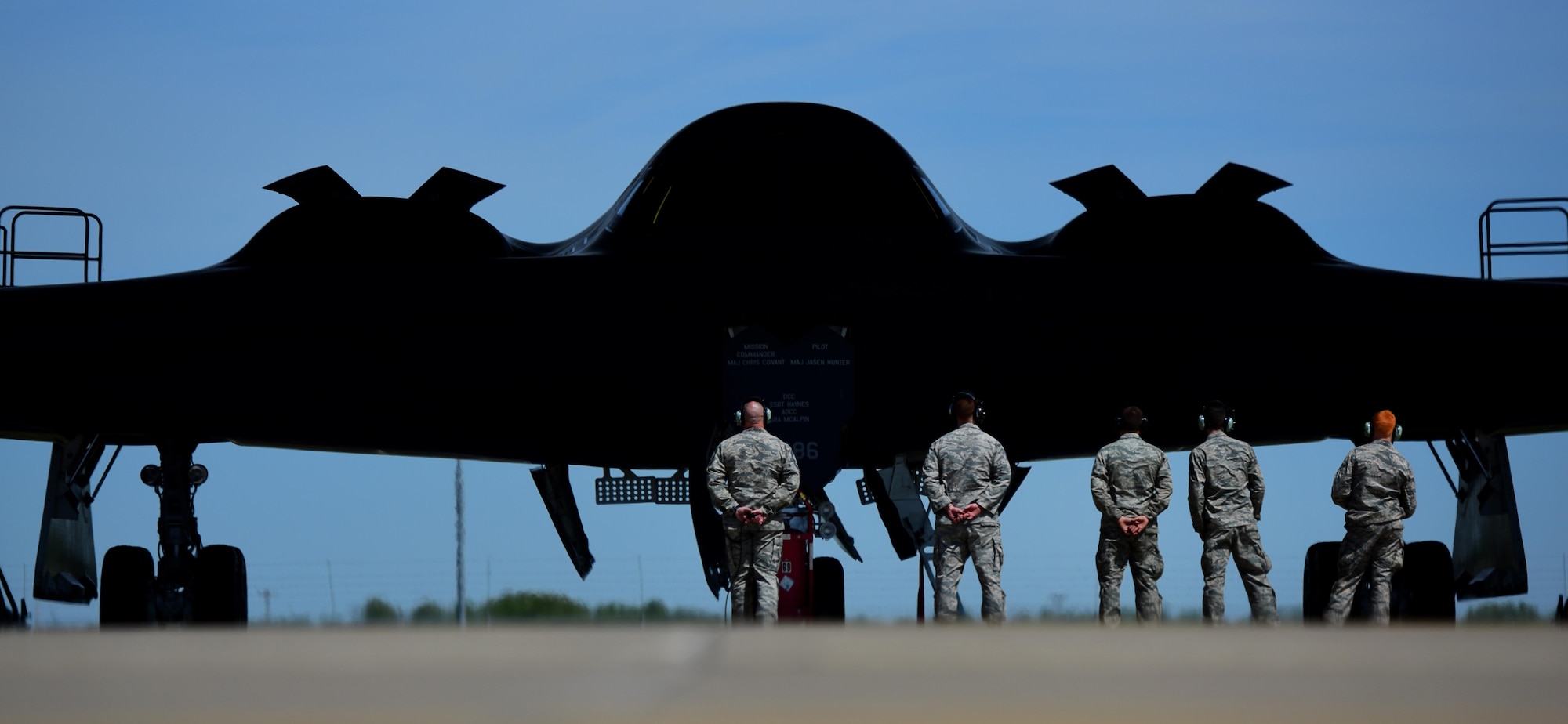 U.S. Air Force Chief Master Sgt. Darron Hunter, the 509th Maintenance Group (MXG) superintendent, performs pre-flight checks on a B-2 Spirit and signals to the mission commander that he is clear and free to move to the runway at Whiteman Air Force Base, Mo., April 24, 2017. During Hunter’s first assignment at Whiteman, he served as the dedicated crew chief (DCC) on the Spirit of Kitty Hawk, tail number 93-1086, from 2000 to 2002, before moving into Quality Assurance and Production for another seven years. In 2015, Hunter returned to the 509th as the MXG superintendent, bringing his career full circle before retiring. For one last farewell, Hunter once more performed the role of the DCC for his old aircraft, "1086." (U.S. Air Force photo by Airman 1st Class Jazmin Smith)