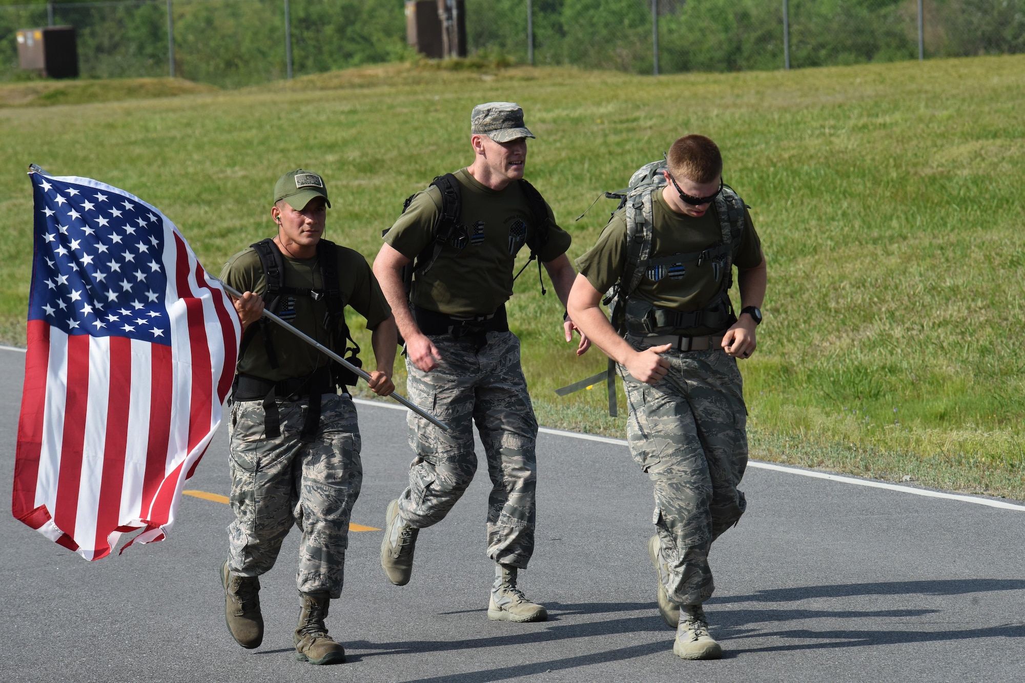 Airman Xavier De Leon (left), and Airman Calahan Ross (right), 4th Security Forces Squadron entry controllers finish an 8.3-mile ruck march during police week, April 17, 2017, at Seymour Johnson Air Force Base, North Carolina. Police week was created in 1962 by then President John F. Kennedy in honor of Peace Officers Memorial Day on May 15. (U.S. Air Force photo by Airman 1st Class Miranda A. Loera)