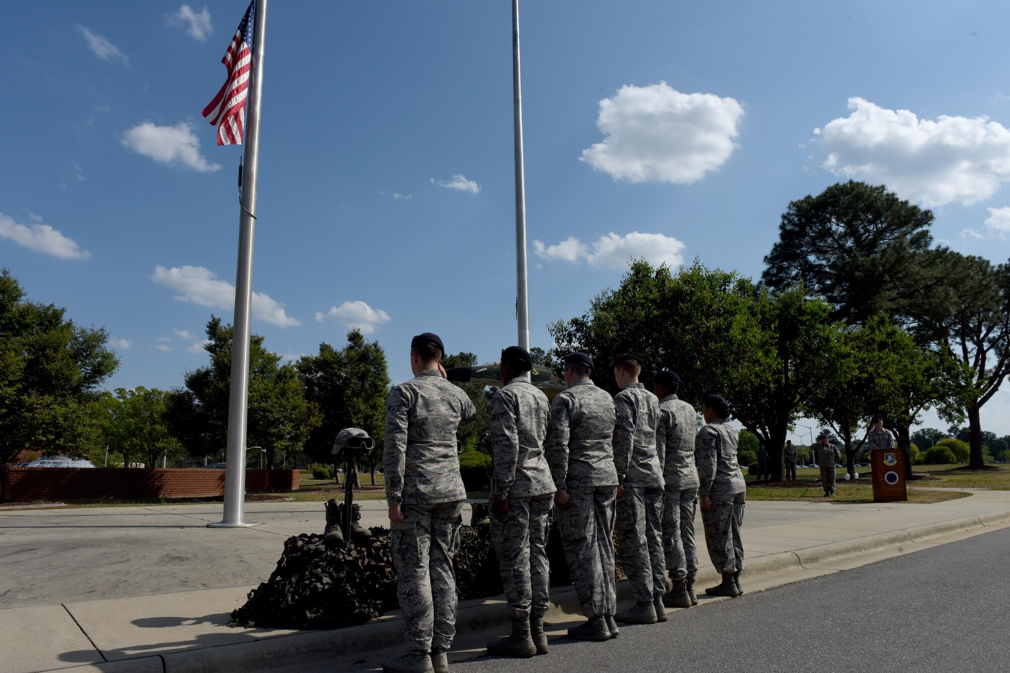 Members of the 4th Security Forces Squadron render salutes to honor the fallen police officers during the closing ceremony of Police week, April 21, 2017, at Seymour Johnson Air Force Base, North Carolina. Police Week is a five-day celebration with events such as an 8.3- mile ruck march, community day and a shoot, move and communicate challenge.  (U.S. Air Force photo by Airman 1st Class Miranda A. Loera)