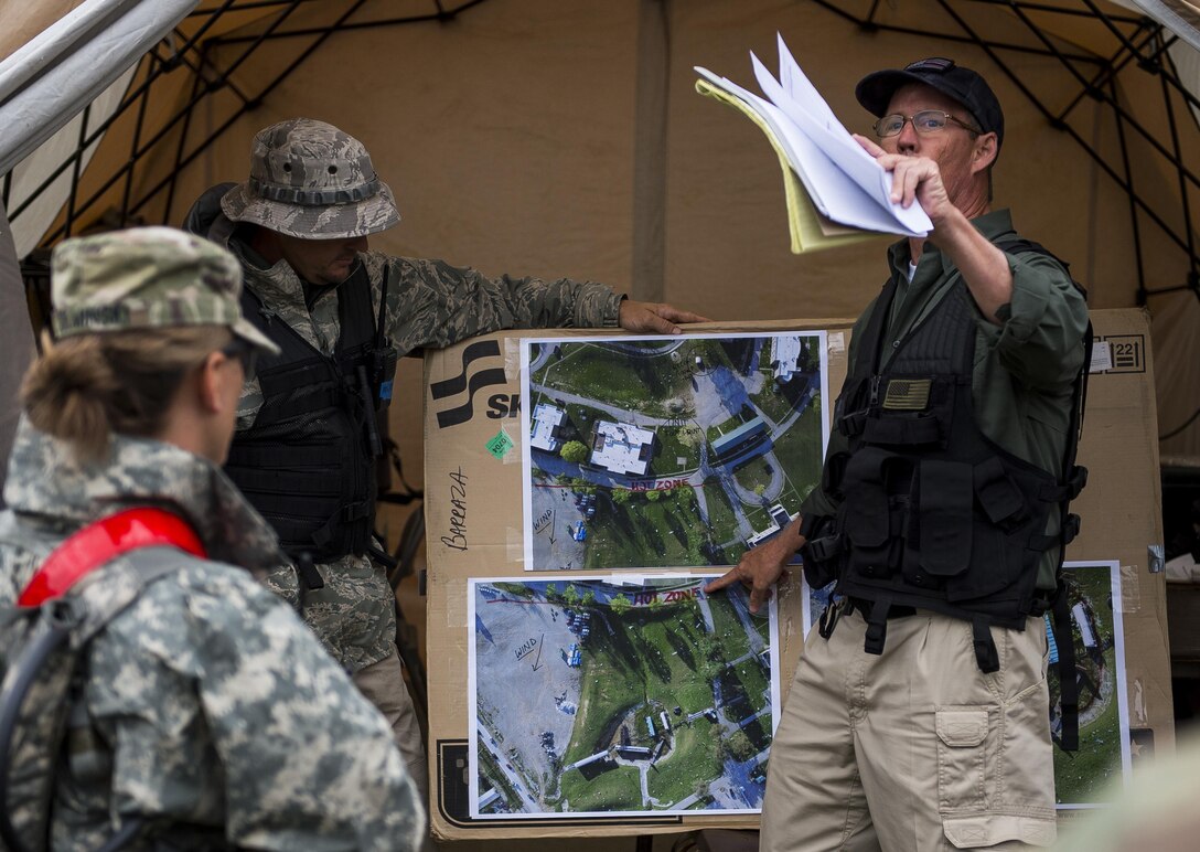 John Sherry, an expert in urban search and rescue and catastrophe response, briefs a platoon of U.S. Army Soldiers from the 51st Chemical Biological Radiological Nuclear Company, of Fort Stewart, Georgia, during Guardian Response 17 at the Muscatatuck Urban Training Center, Indiana, April 27, 2017. Guardian Response, as part of Vibrant Response, is a multi-component training exercise run by the U.S. Army Reserve designed to validate nearly 4,000 service members in Defense Support of Civil Authorities (DSCA) in the event of a Chemical, Biological, Radiological and Nuclear (CBRN) catastrophe. This year's exercise simulated an improvised nuclear device explosion with a source region electromagnetic pulse (SREMP) out to more than 4 miles. The 84th Training Command is the hosting organization for this exercise, with the training operations run by the 78th Training Division, headquartered in Fort Dix, New Jersey. (U.S. Army Reserve photo by Master Sgt. Michel Sauret)