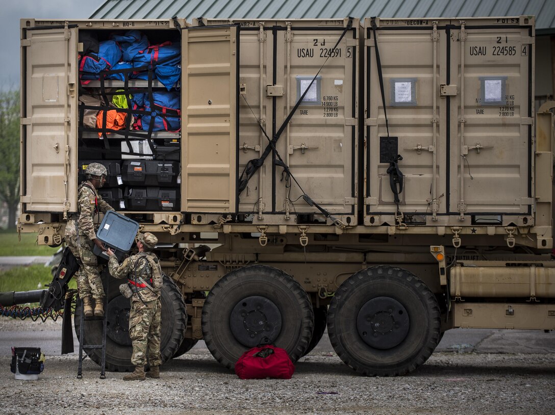 Pfc. Sebastian Arviso and Pfc. Jordan Reynolds, U.S. Army Soldiers from the 51st Chemical Biological Radiological Nuclear Company, of Fort Stewart, Georgia, unload a container of equipment during Guardian Response 17 at the Muscatatuck Urban Training Center, Indiana, April 27, 2017. Guardian Response, as part of Vibrant Response, is a multi-component training exercise run by the U.S. Army Reserve designed to validate nearly 4,000 service members in Defense Support of Civil Authorities (DSCA) in the event of a Chemical, Biological, Radiological and Nuclear (CBRN) catastrophe. This year's exercise simulated an improvised nuclear device explosion with a source region electromagnetic pulse (SREMP) out to more than 4 miles. The 84th Training Command is the hosting organization for this exercise, with the training operations run by the 78th Training Division, headquartered in Fort Dix, New Jersey. (U.S. Army Reserve photo by Master Sgt. Michel Sauret)
