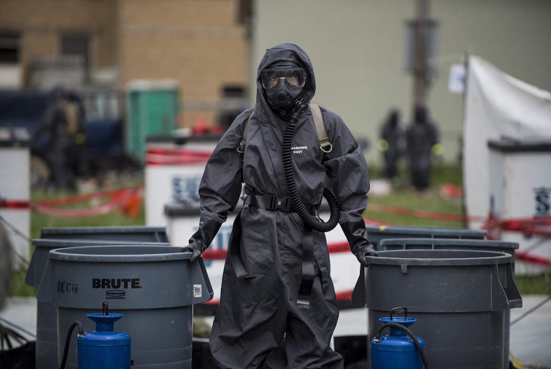 A U.S. Army Soldier with the 51st Chemical Biological Radiological Nuclear Company, of Fort Stewart, Georgia, stands watch at a decontamination field site during Guardian Response 17 at the Muscatatuck Urban Training Center, Indiana, April 27, 2017. Guardian Response, as part of Vibrant Response, is a multi-component training exercise run by the U.S. Army Reserve designed to validate nearly 4,000 service members in Defense Support of Civil Authorities (DSCA) in the event of a Chemical, Biological, Radiological and Nuclear (CBRN) catastrophe. This year's exercise simulated an improvised nuclear device explosion with a source region electromagnetic pulse (SREMP) out to more than 4 miles. The 84th Training Command is the hosting organization for this exercise, with the training operations run by the 78th Training Division, headquartered in Fort Dix, New Jersey. (U.S. Army Reserve photo by Master Sgt. Michel Sauret)