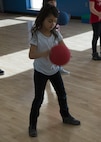 A Youth Center child exercises with a fitness ball during an event at the McAdoo Fitness Center at Minot Air Force Base, N.D., April 17, 2017. This group of second and third-graders participated in a mock fitness assessment, bounce house, a video exercise with fitness balls and wallyball. (U.S. Air Force photo/Airman 1st Class Alyssa M. Akers)