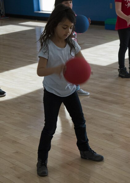 A Youth Center child exercises with a fitness ball during an event at the McAdoo Fitness Center at Minot Air Force Base, N.D., April 17, 2017. This group of second and third-graders participated in a mock fitness assessment, bounce house, a video exercise with fitness balls and wallyball. (U.S. Air Force photo/Airman 1st Class Alyssa M. Akers)