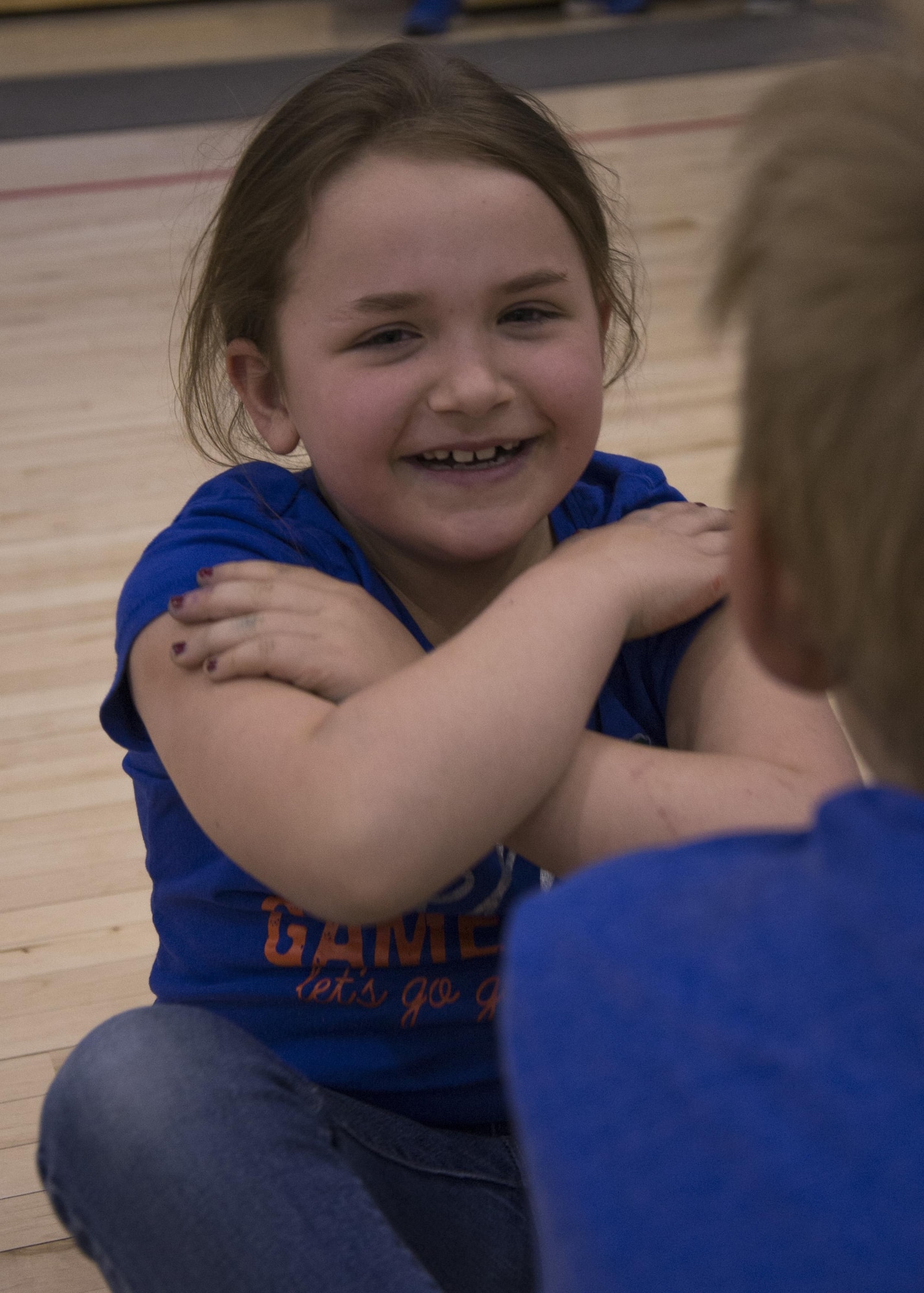 A Youth Center child participates in a mock fitness assessment during an event at the McAdoo Fitness Center at Minot Air Force Base, N.D., April 17, 2017. The mock fitness assessment consisted of one minute of both pushups and situps as well as running a few laps around basketball courts. (U.S. Air Force photo/Airman 1st Class Alyssa M. Akers)