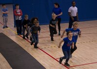 Youth Center children begin the run portion of a mock fitness assessment during an event at the McAdoo Fitness Center at Minot Air Force Base, N.D., April 17, 2017. The mock fitness assessment consisted of one minute of both pushups and situps as well as running a few laps around basketball courts. (U.S. Air Force photo/Airman 1st Class Alyssa M. Akers)