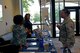 U.S. Air Force Staff Sgt. Heather Moore, 20th Force Support Squadron manpower analyst, speaks with Sanetta Holder, school representative, during the Spring Education Fair at Shaw Air Force Base, S.C., April 26, 2017. During the fair, school representatives answered questions from Team Shaw members about what their respective schools could offer a prospective student. (U.S. Air Force photo by Airman 1st Class Destinee Sweeney)