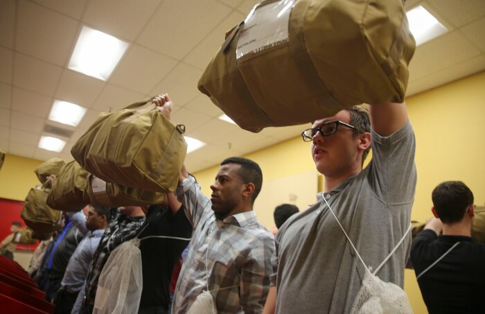 Recruits from Hotel Company, 2nd Recruit Training Battalion, hold up their war bags during receiving at Marine Corps Recruit Depot San Diego, April 17. The war bags are part of the recruits’ initial gear, and they will receive the rest of their gear at the end of the week. Annually, more than 17,000 males recruited from the Western Recruiting Region are trained at MCRD San Diego. Hotel Company is scheduled to graduate July 14.