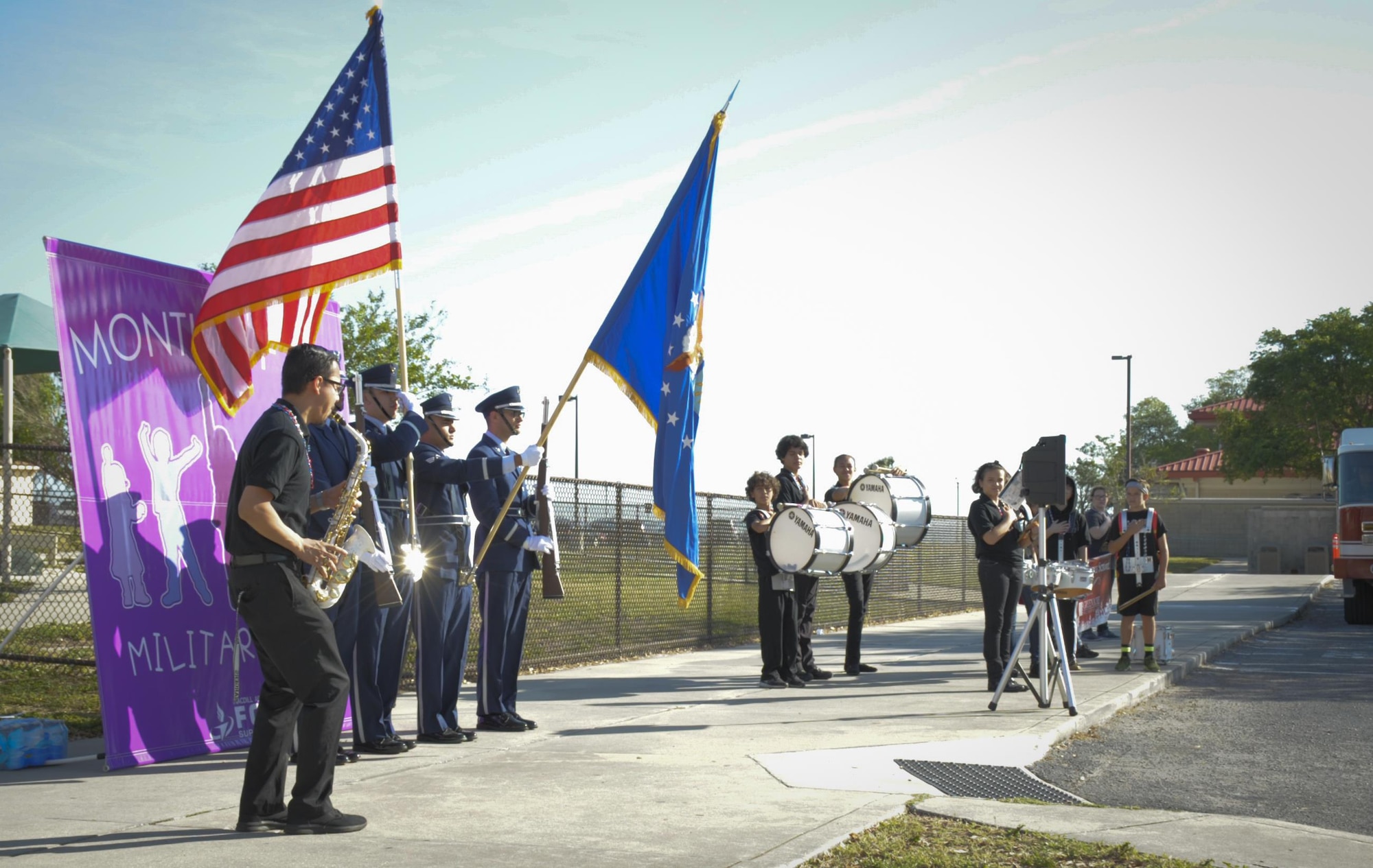 The Robinson Middle School band plays the National Anthem as MacDill’s Base Honor Guard presents the colors before the Month of the Military Child parade at MacDill Air Force Base, Fla., April 21, 2017. Team MacDill came together and lined the parade route to show support to their military children. (U.S. Air Force photo by Airman 1st Class Mariette Adams)