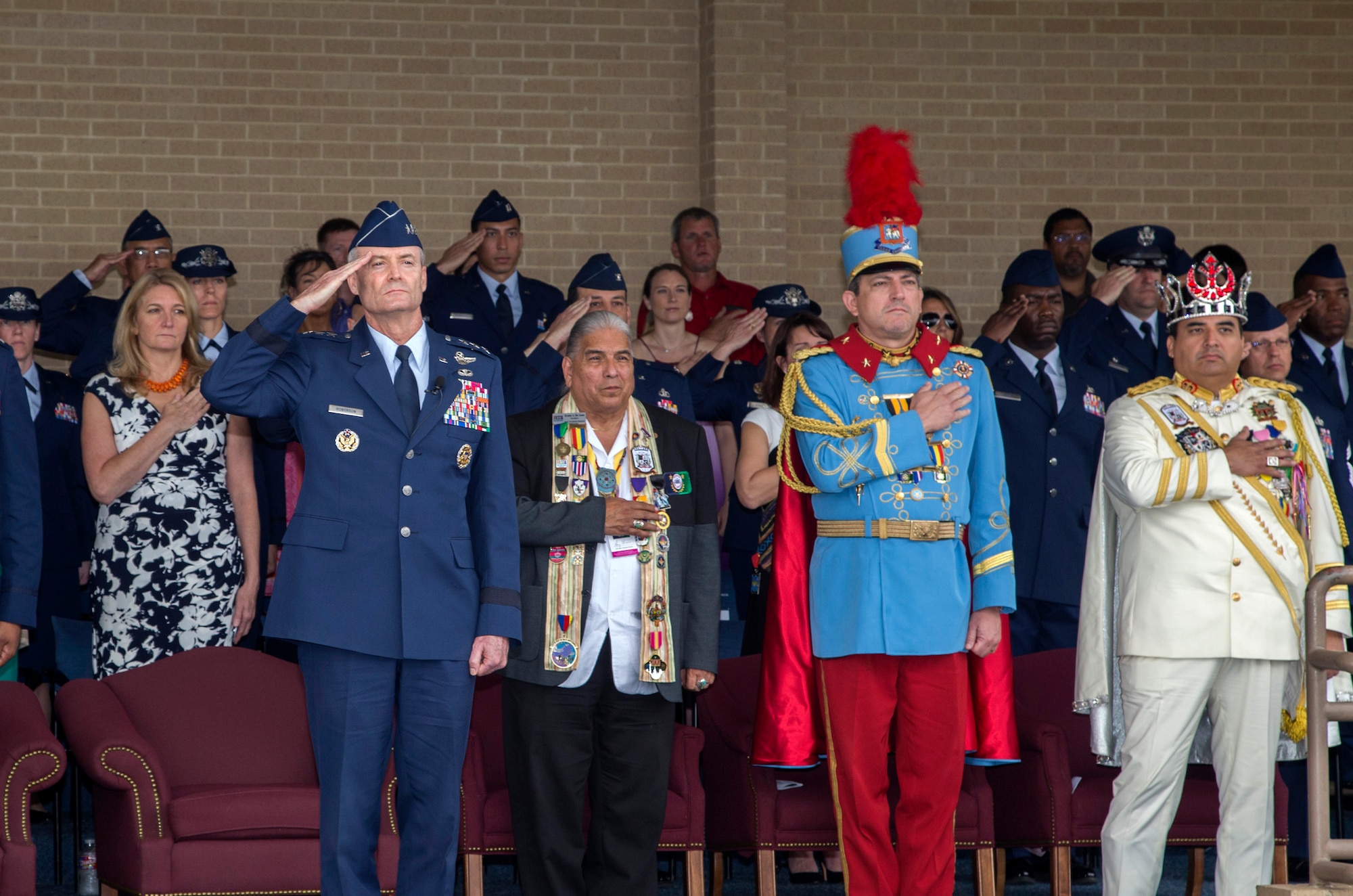 U.S. Air Force Lt. Gen. Darryl Roberson, commander Air Education and Training command, salutes Basic Military Training graduates alongside the 2017 Fiesta Royalty April 21, 2017 at the Graduation Parade at Lackland Air Force Base, T.X. This year marks the 126th anniversary of the colorful Fiesta festivity, honoring traditions deeply rooted throughout the area and celebrating the historic partnerships between the Airmen of Joint Base San Antonio and the local community. (U.S. Air Force photo by Johnny Saldivar) 