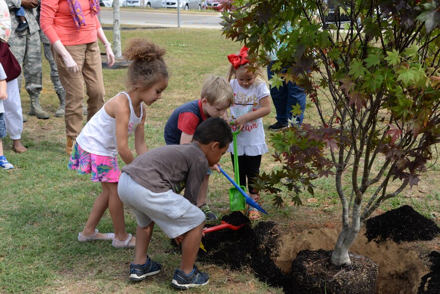 Children from the 14th Flying Training Wing Child Development Center plant a Japanese Maple tree in honor of Arbor Day April 21, 2017, Columbus Air Force Base, Mississippi. The Child Development Center will use the tree to show children how important they are to the environment, and will charge the children with watering and caring for the tree.