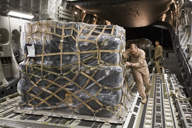 MARINE CORPS AIR STATION CHERRY POINT, N.C. – U.S. Air Force Maj. Robert Riggs, U.S. Marine Corps Forces, Special Operations Command air mobility liaison officer (AMLO), assists in loading cargo aboard a C-17 aircraft at MCAS Cherry Point. As MARSOC’s AMLO, Riggs provides a critical link of communication between the airlift and ground forces in the area of operations. He facilitated the mission from planning and coordination through hands-on facilitation by piloting the aircraft as it deployed and re-deployed two MARSOC units. (U.S. Marine Corps photo by Sgt. Salvador Moreno, released)