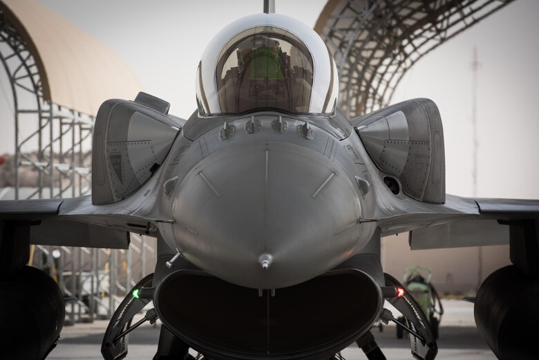 A Polish air force pilot performs preflight checks in an F-16 Fighting Falcon before taxiing for a mission at the 407th Air Expeditionary Group, April 24, 2017. The Polish Airmen are part of the 60-nation coalition force supporting Operation Inherent Resolve in the fight against ISIS. (U.S. Air Force photo/Master Sgt. Benjamin Wilson)(Released)