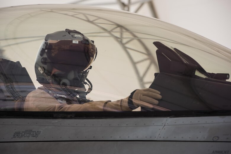 A Polish air force pilot performs preflight checks in an F-16 Fighting Falcon before taxiing for a mission at the 407th Air Expeditionary Group, April 24, 2017. The Polish Airmen are part of the 60-nation coalition force supporting Operation Inherent Resolve in the fight against ISIS. (U.S. Air Force photo/Master Sgt. Benjamin Wilson)(Released)