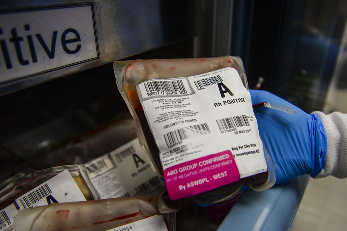 Senior Airman Jessica Tamuzza, 99th Medical Support Squadron laboratory technician, pulls a bag of A positive blood from the blood bank in the Mike O’Callaghan Federal Medical Center at Nellis Air Force Base Nev., April 24, 2017. The blood bank provides patients with much needed blood products in an emergency or during surgeries. (U.S. Air Force photo by Airman 1st Class Nathan Byrnes/Released)