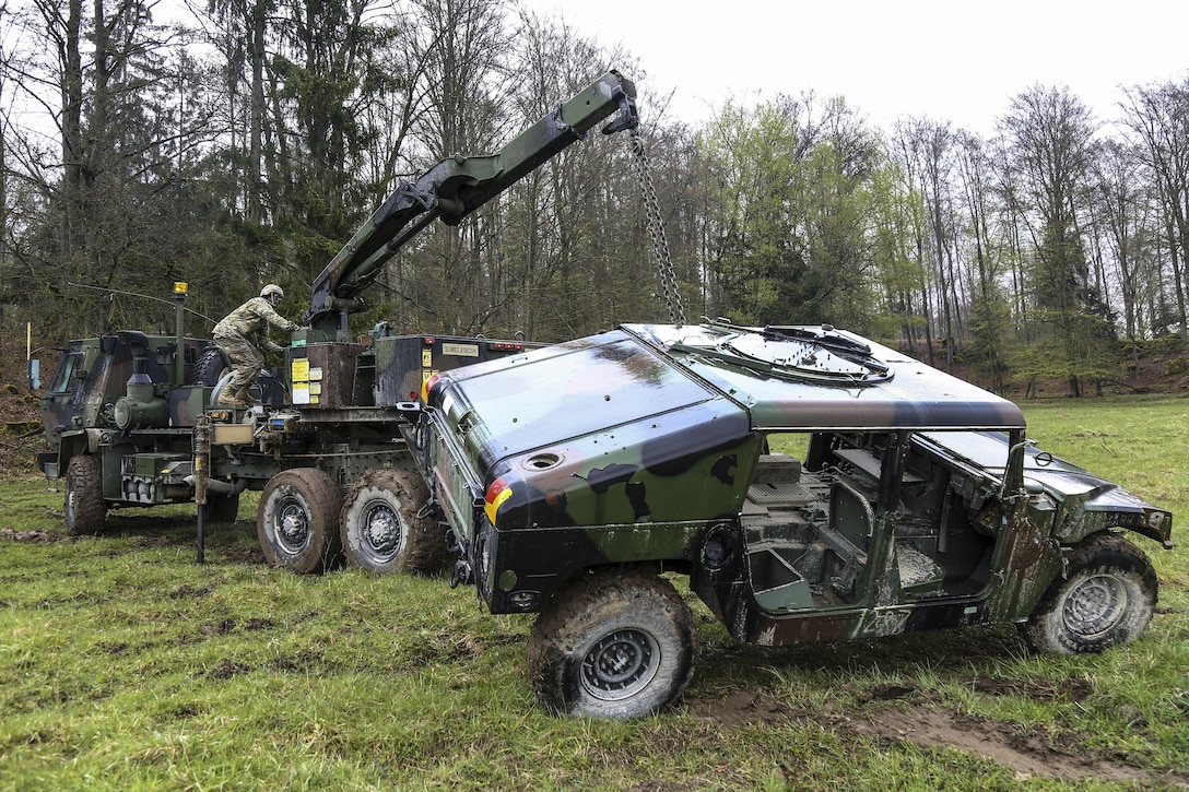 Soldiers lift a Humvee while conducting a vehicle recovery exercise during Saber Junction 17 at the Army Training Command’s Hohenfels Training Area, Germany, April 27, 2017. The exercise, which includes about 4,500 participants from 13 NATO and European partner nations, assesses the readiness of the regiment to conduct unified land operations. Army photo by Spc. Danielle Carver